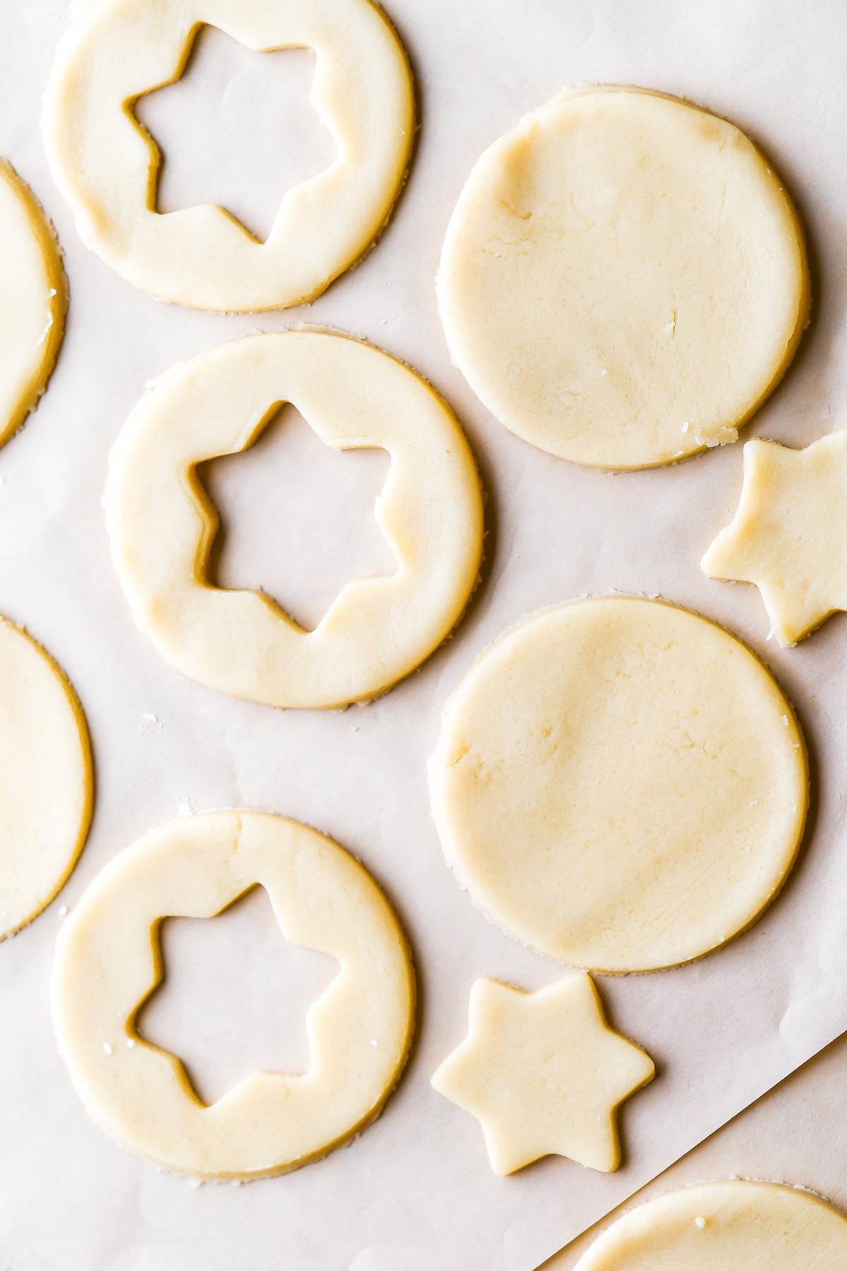 place the cookies on the parchment paper lined baking sheet and cut out the centers of half of them