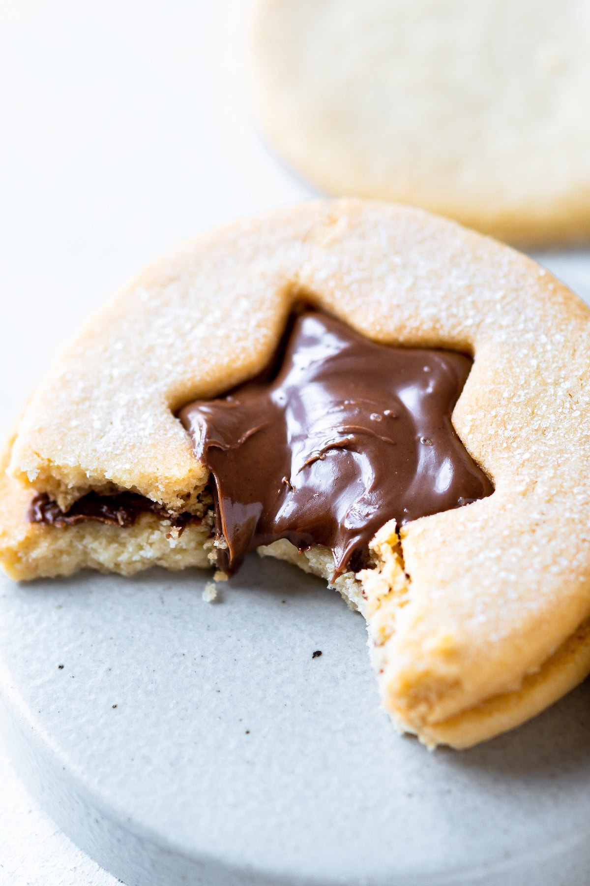 a Nutella Linzer cookie with a bite out