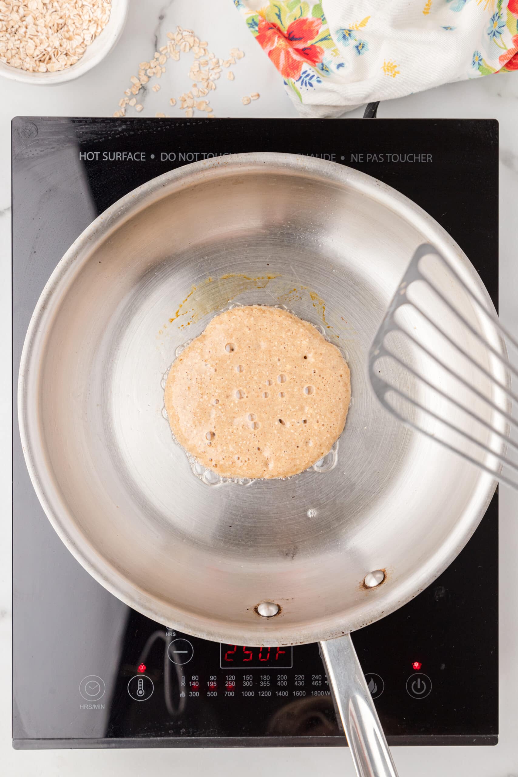 Banana protein batter is being cooked on the skillet to create a pancake