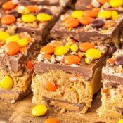 a lot of Reese's No Bake peanut butter bars made with chocolate, peanut butter, Reese's Pieces, and Reese's Peanut Butter Cups