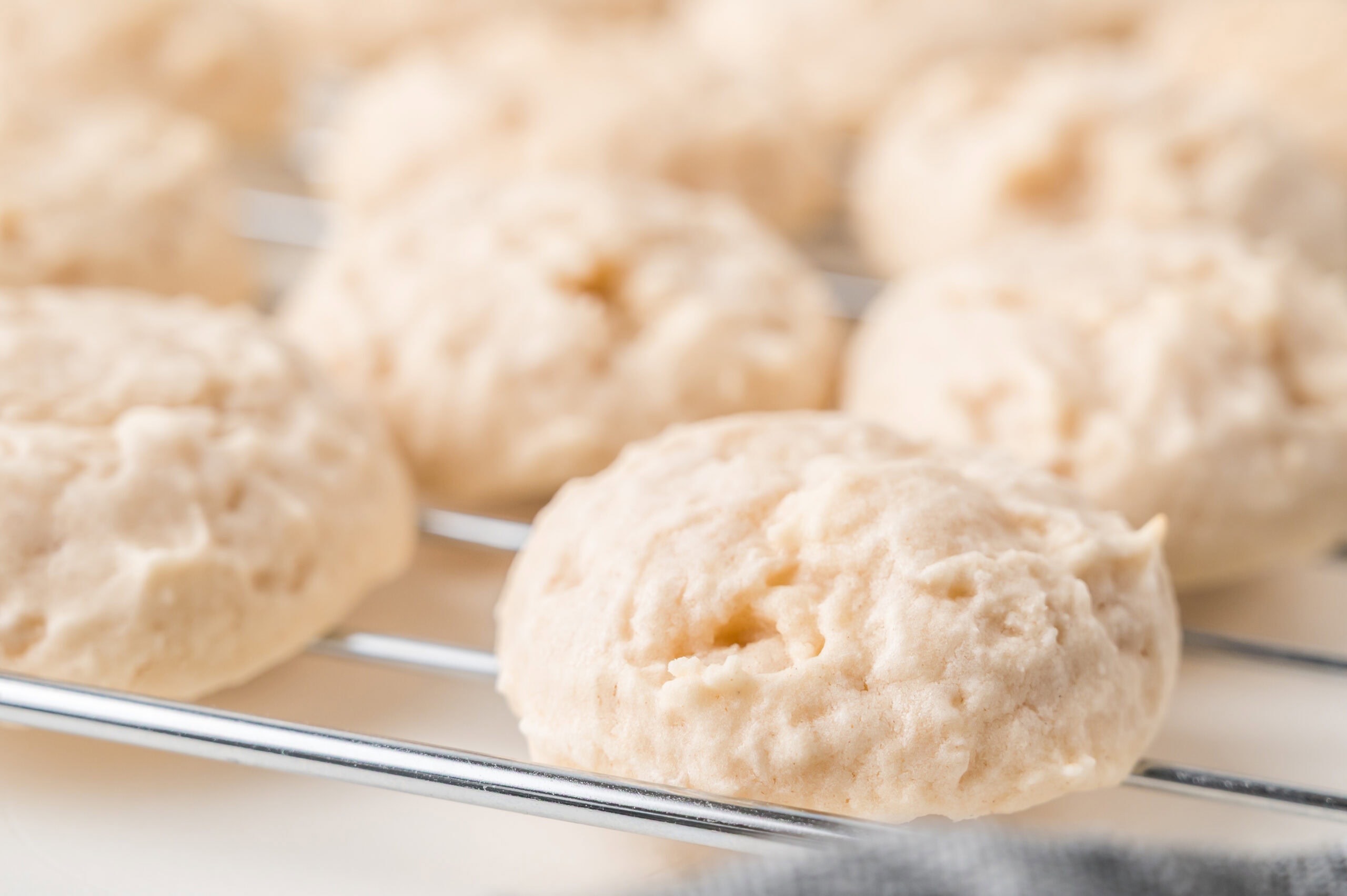 Close up of shortbread cookies, baked and cooling on a wire rack