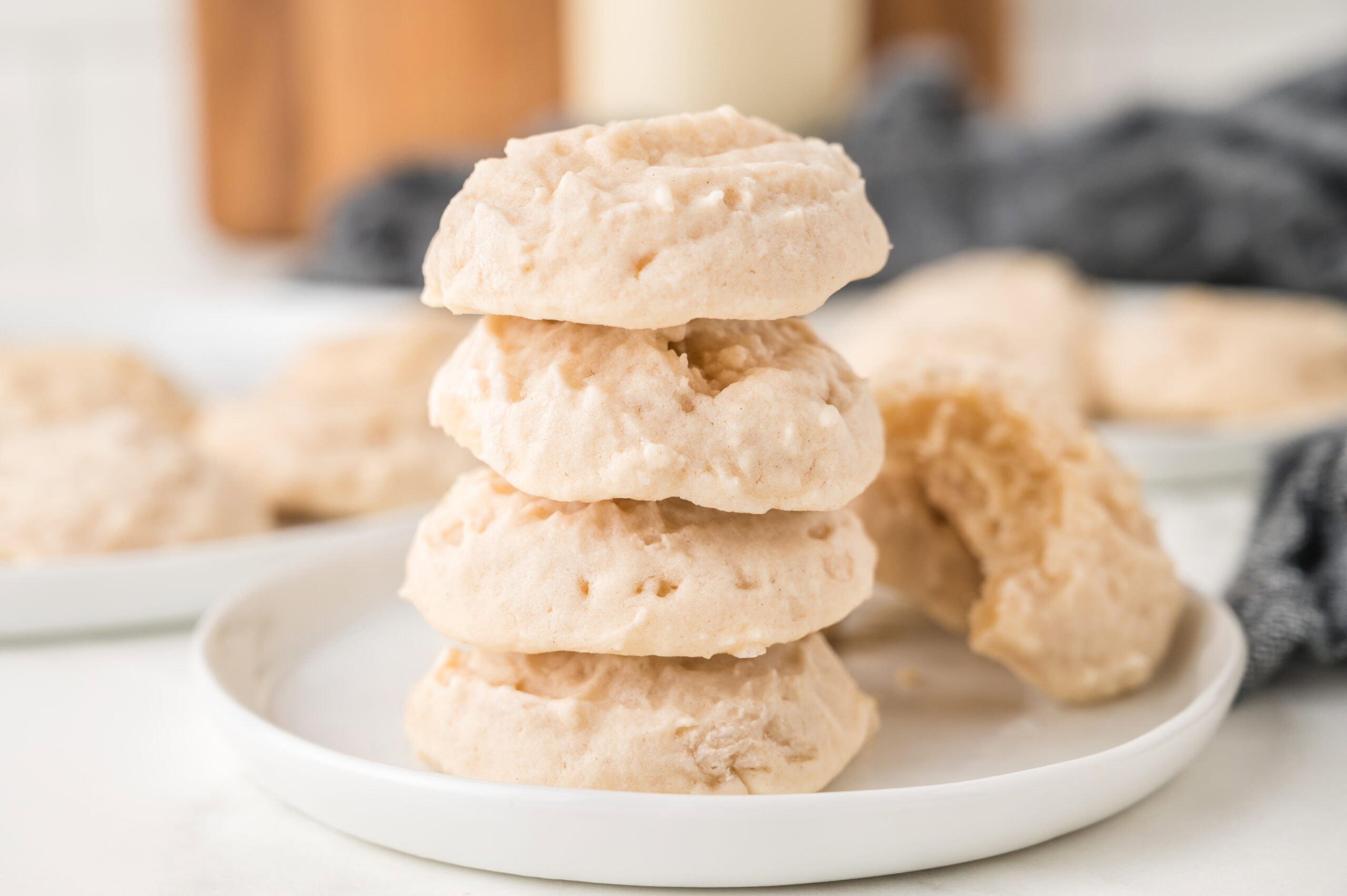 A stack of four shortbread cookies on a plate