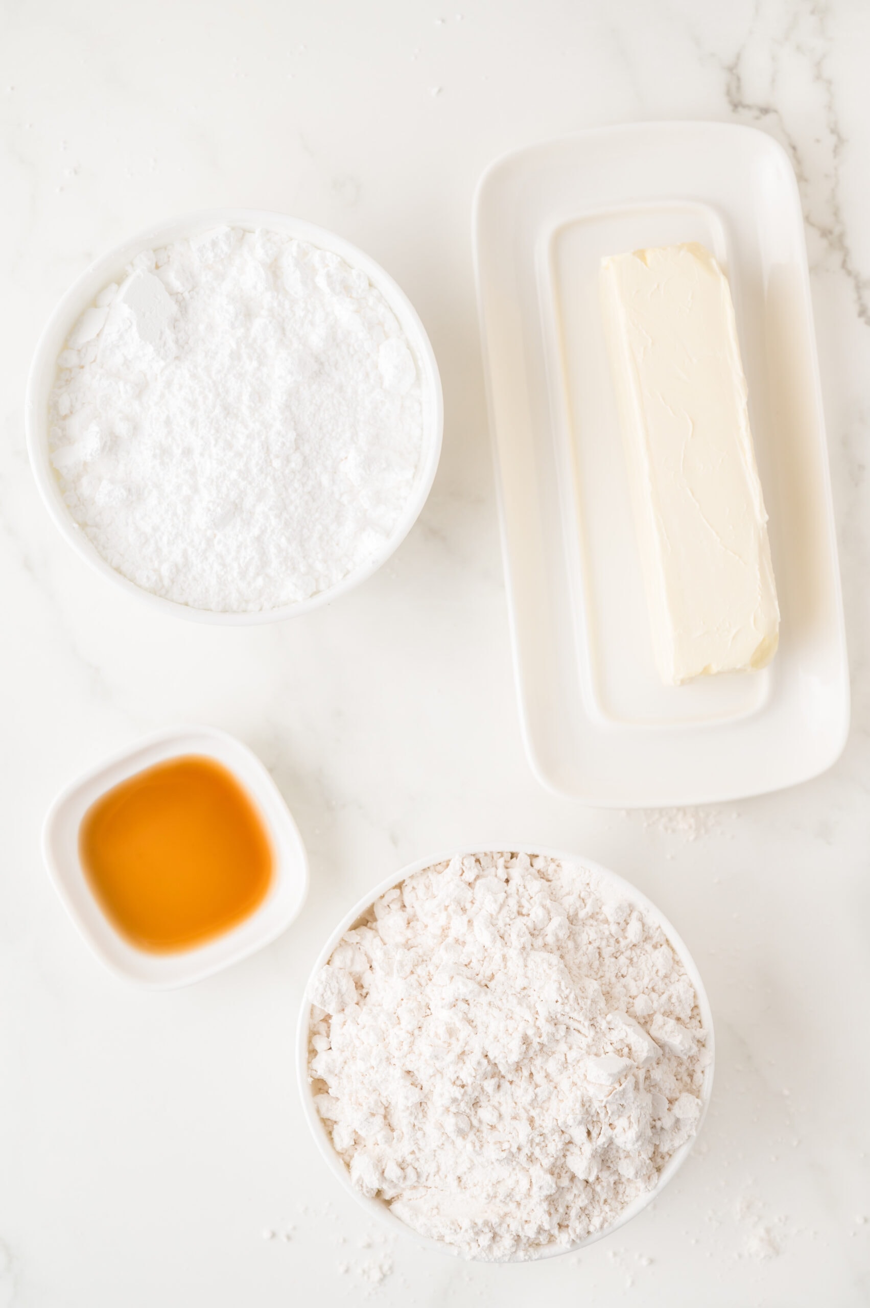 All ingredients shown: butter, flour, powdered sugar, vanilla