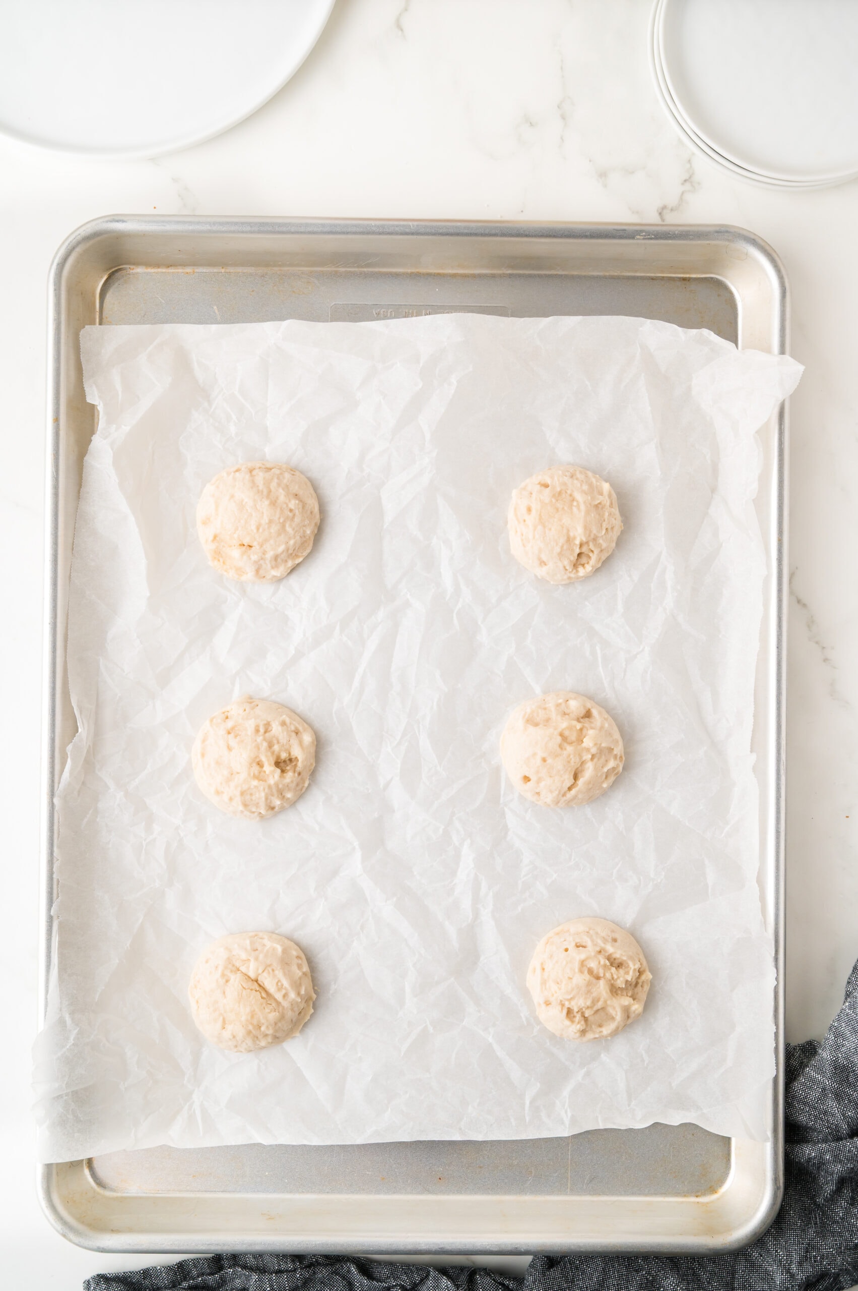 Shortbread cookie dough placed on a baking sheet, ready to be baked.