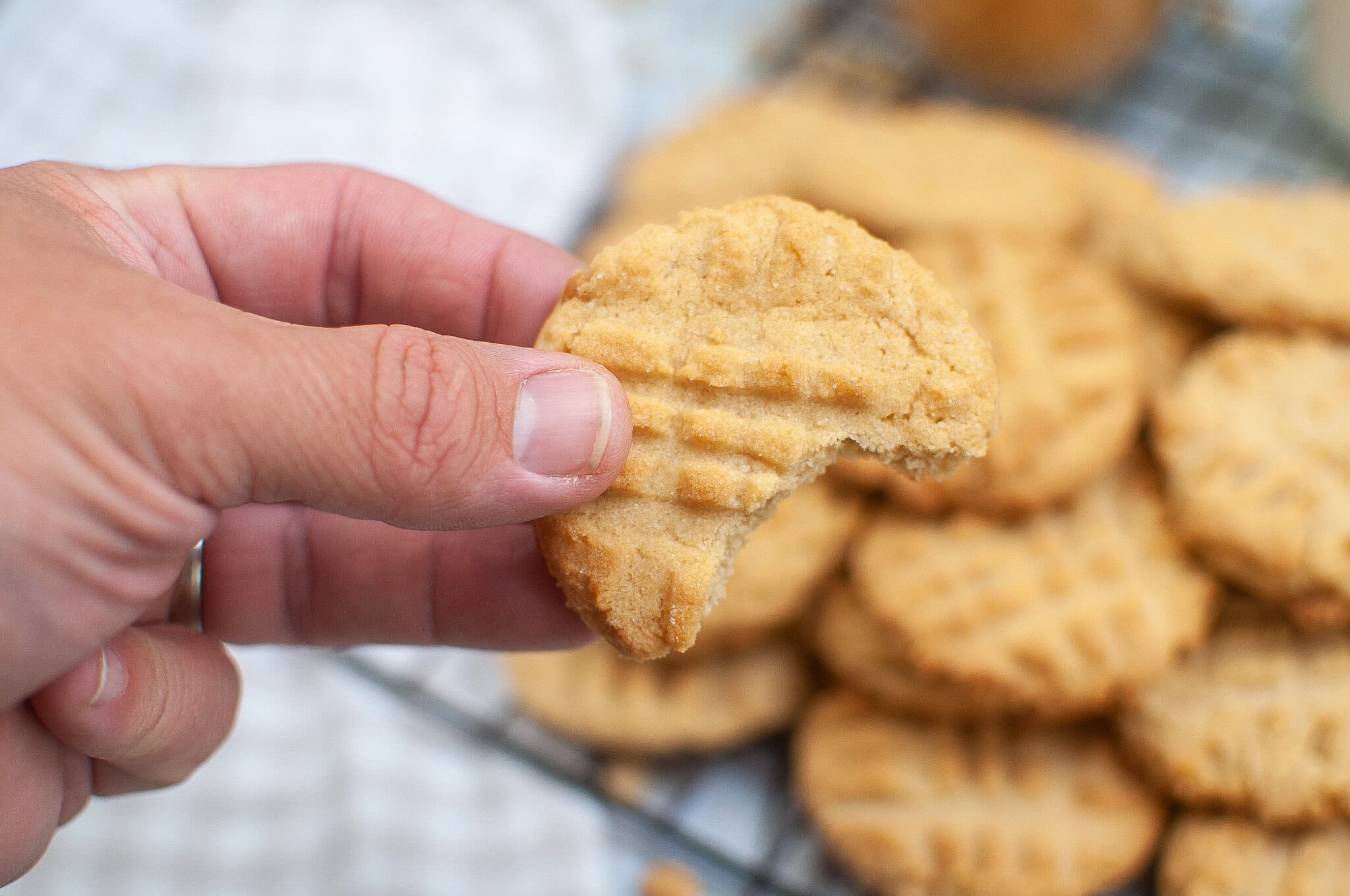 Close up of a air fryer peanut butter cookie with a bite taken out of it