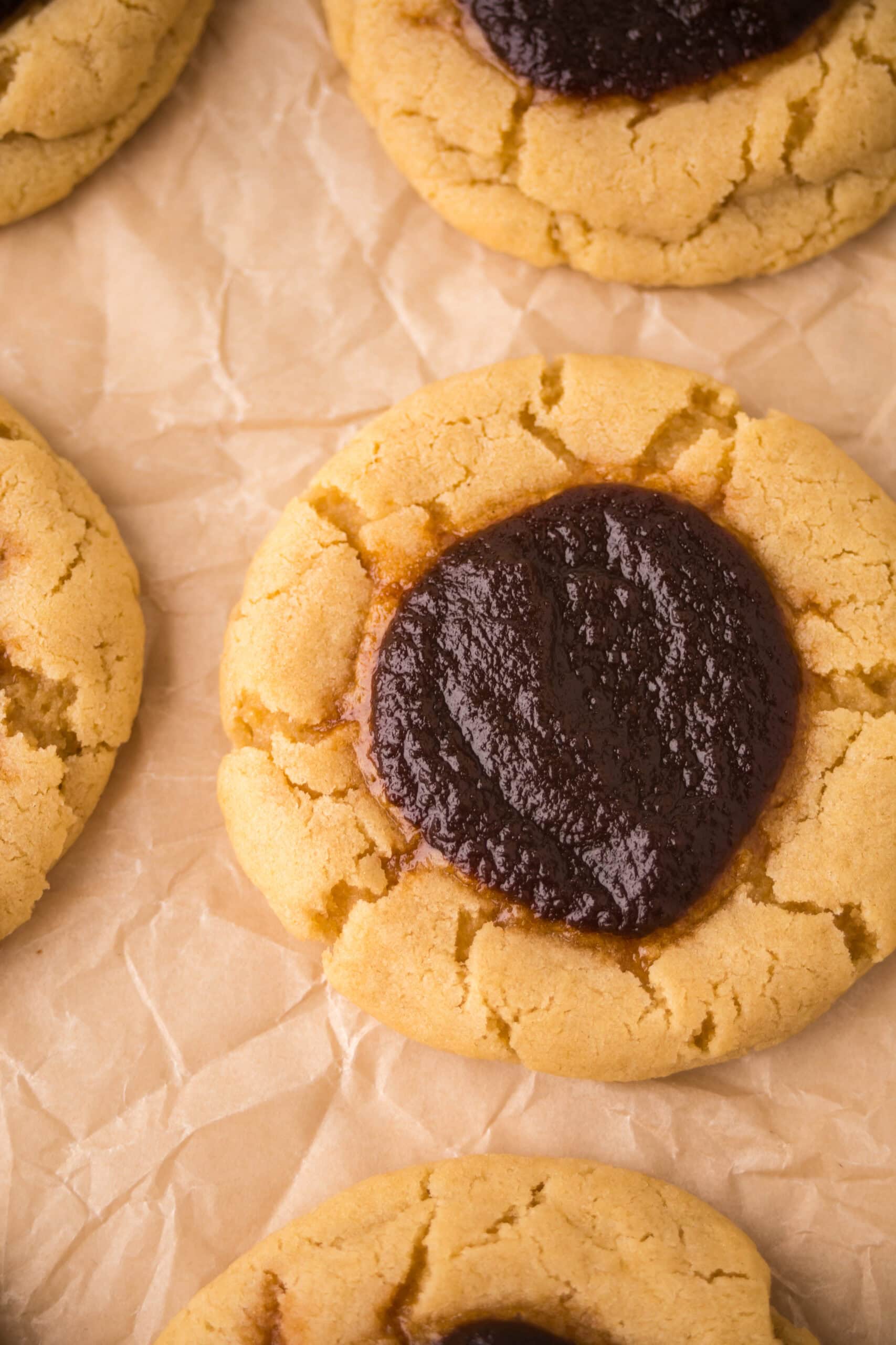 Close up of an apple butter thumbprint cookie, showing its texture