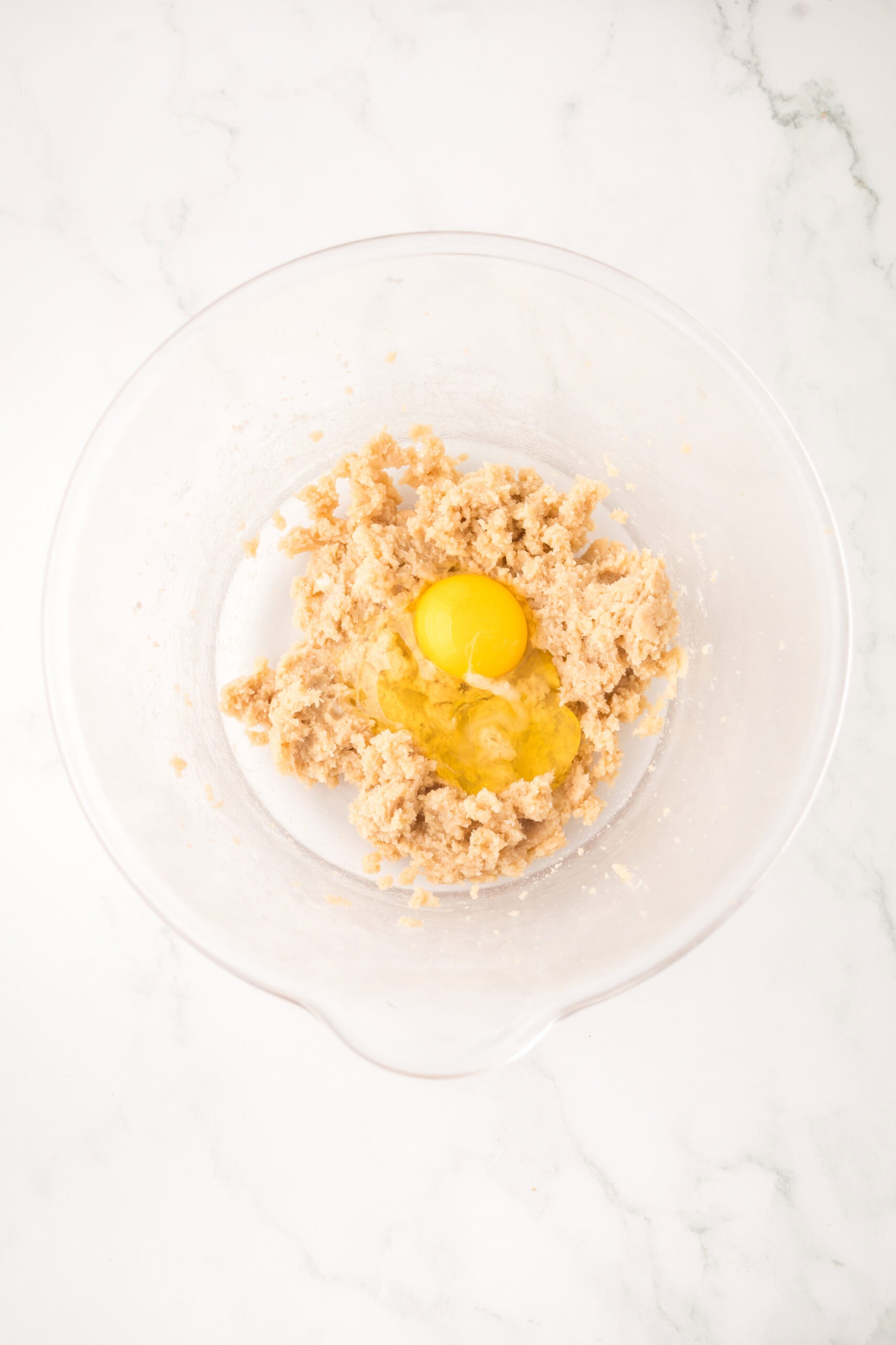 Whisking in the egg into the butter, sugar mixture
