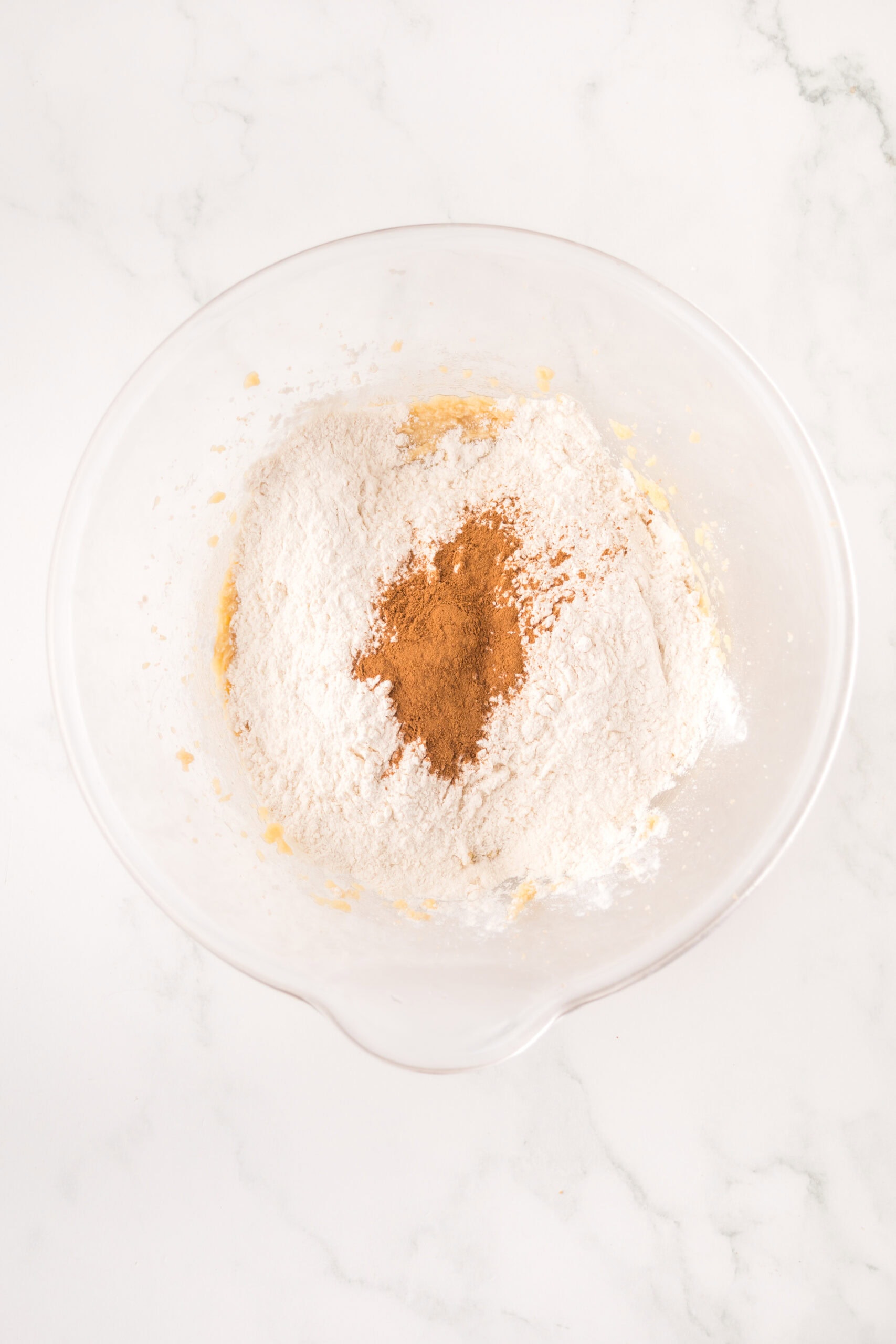 In a mixing bowl: flour, cinnamon, baking soda, baking powder is combinec