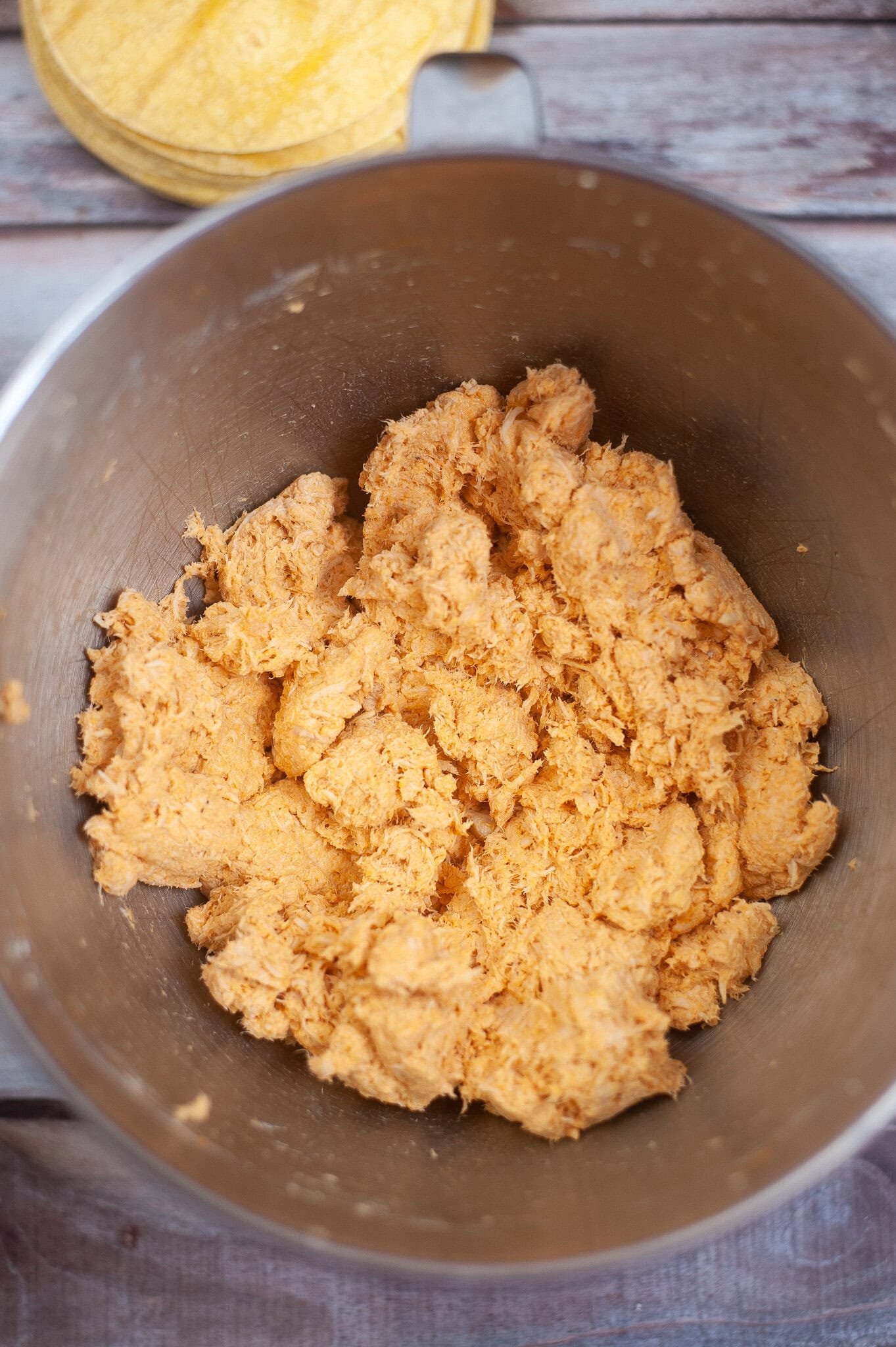 Chicken mixture in a bowl: Chicken, hot sauce, ranch, and garlic. Mixed up and ready to be rolled into a tortilla.