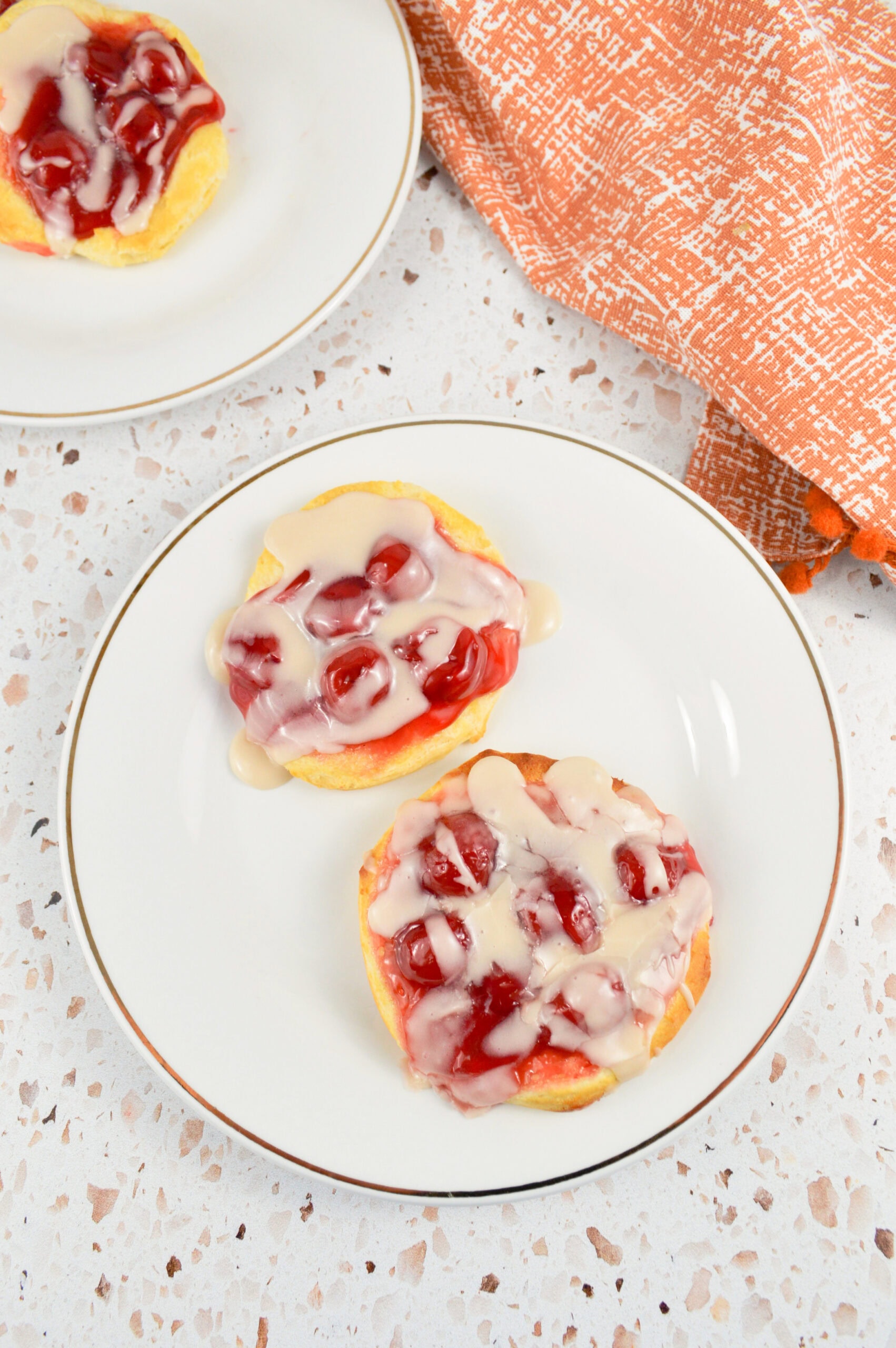 Plated cherry danish with an almond glazed, all cooled and ready to be enjoyed and served