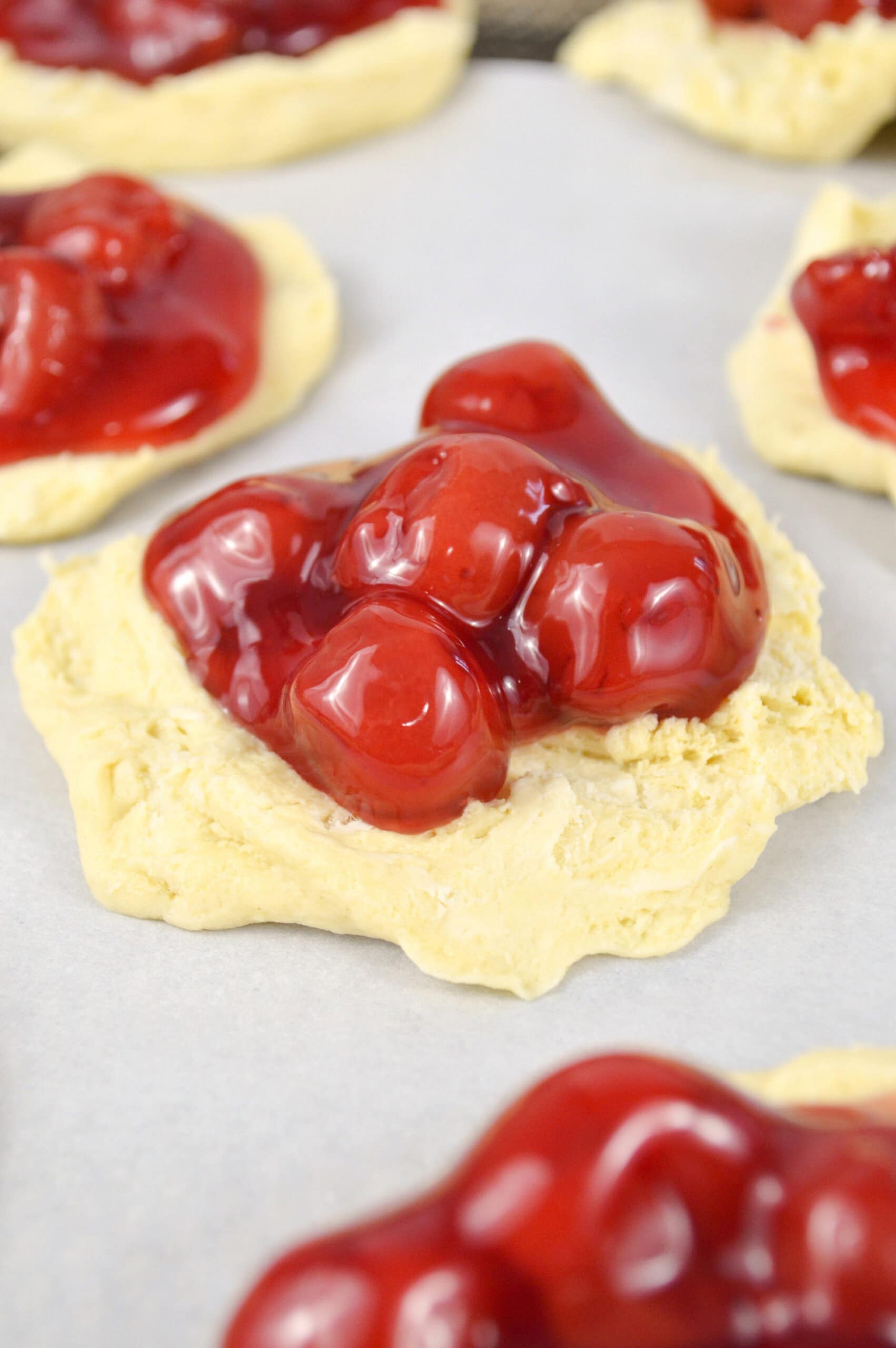 Process photo of showing the cherry filling on the biscuit rounds