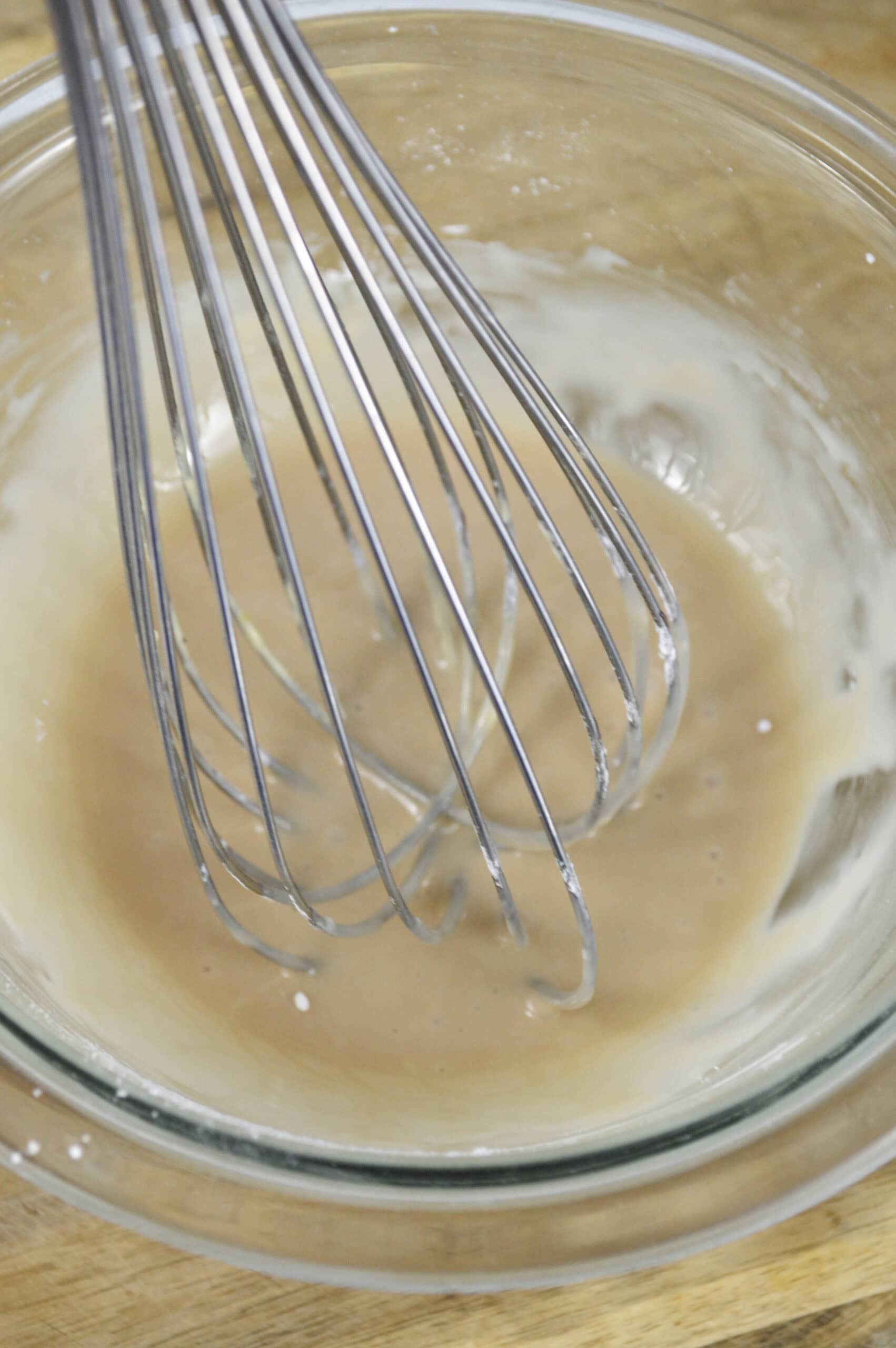 Process of whisking powdered sugar, milk and almond extract