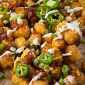 cheesy loaded tater tots with cheddar, bacon, and ranch sour cream