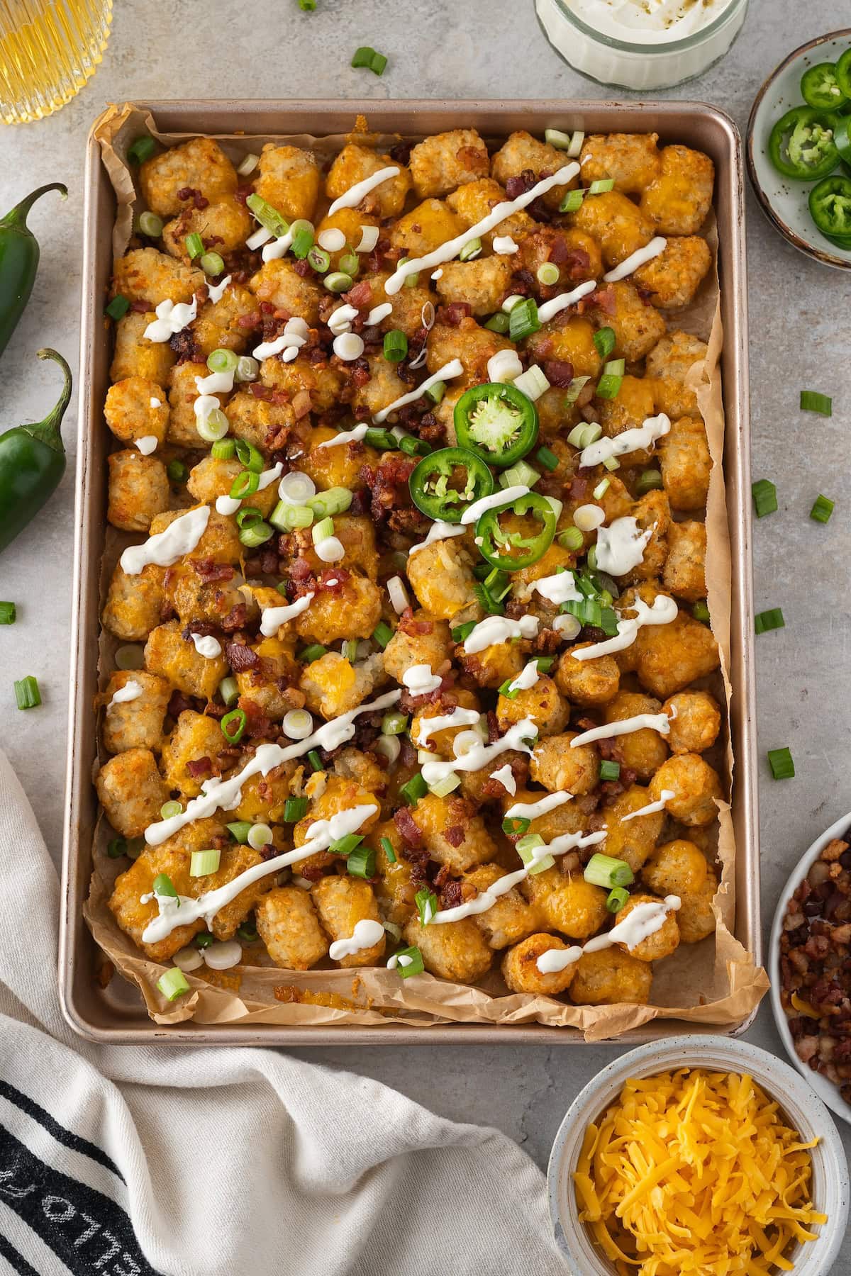 drizzle the loaded tater tots with ranch sour cream