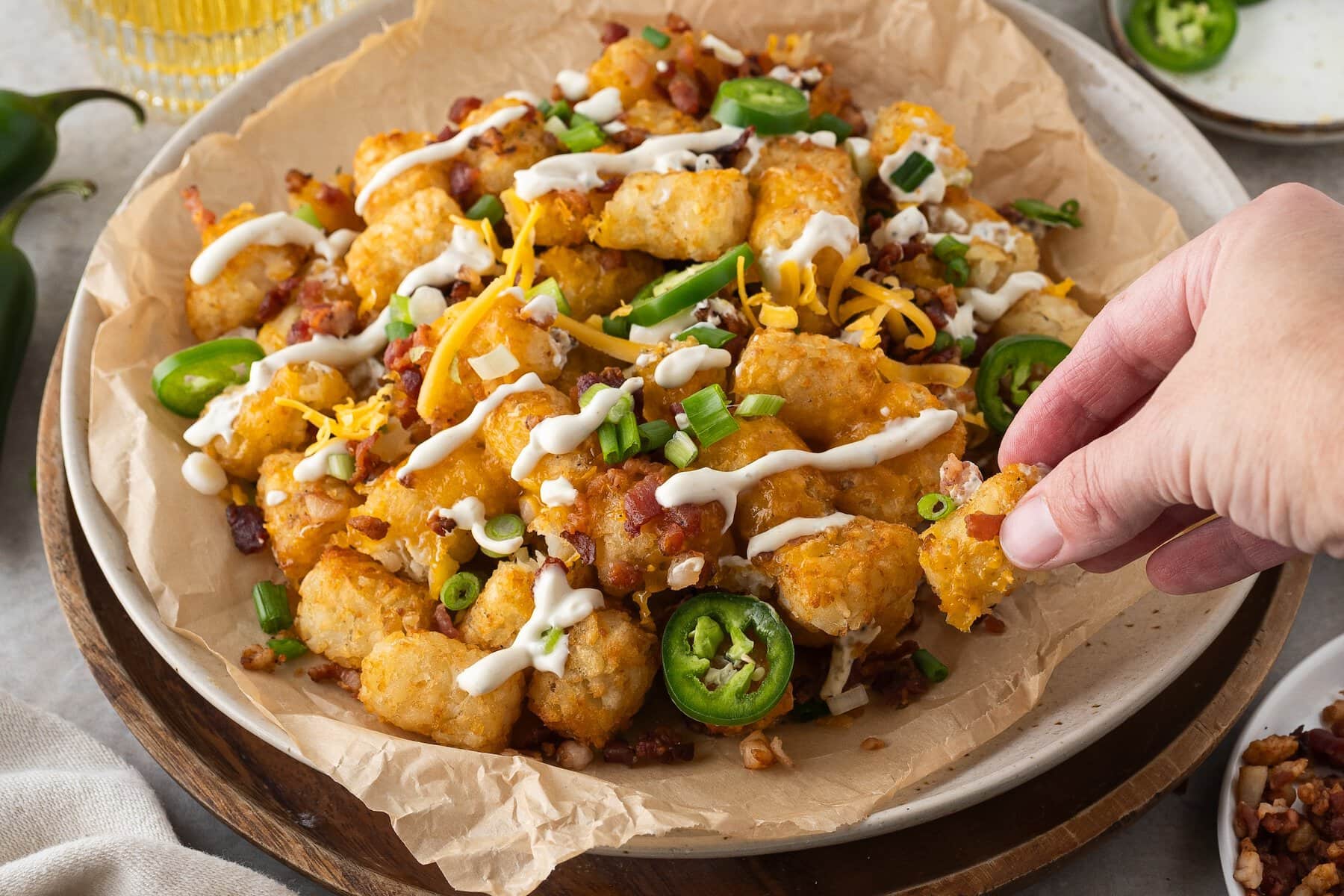 a plate of loaded tater tots nachos