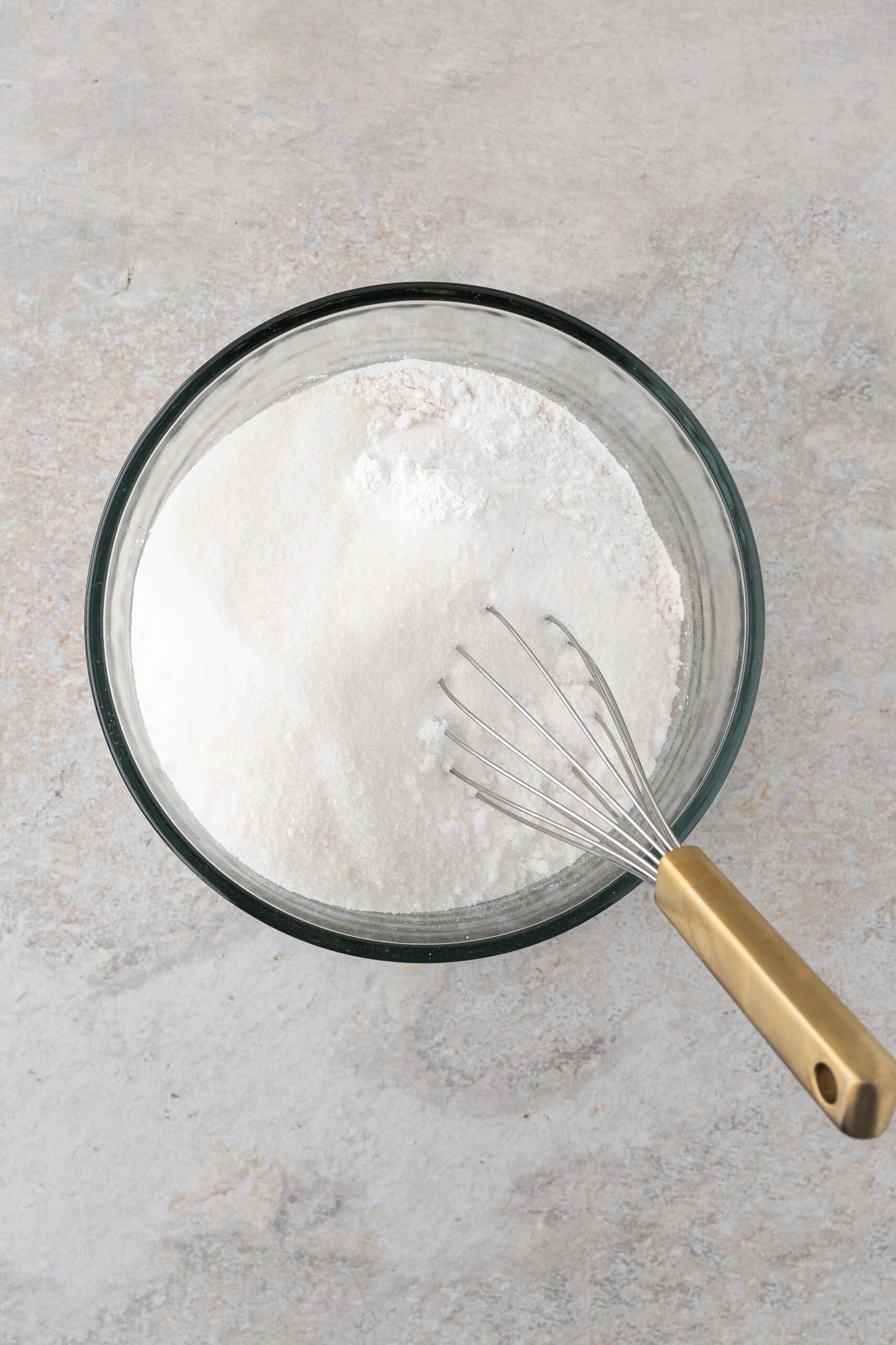 Dry ingredients: flour, baking powder, salt and granulated sugar ready to be whisk in a medium size bowl