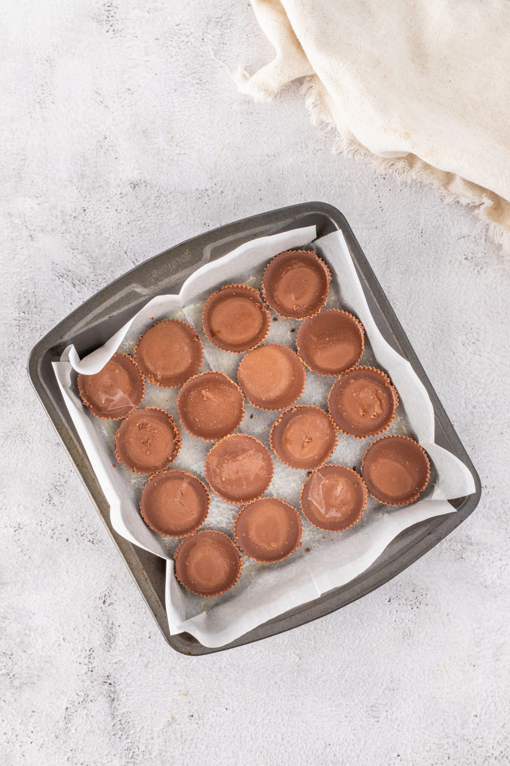Processing photo of lining the bottom of the pan with Reese's Peanut Butter Cups turned upside down