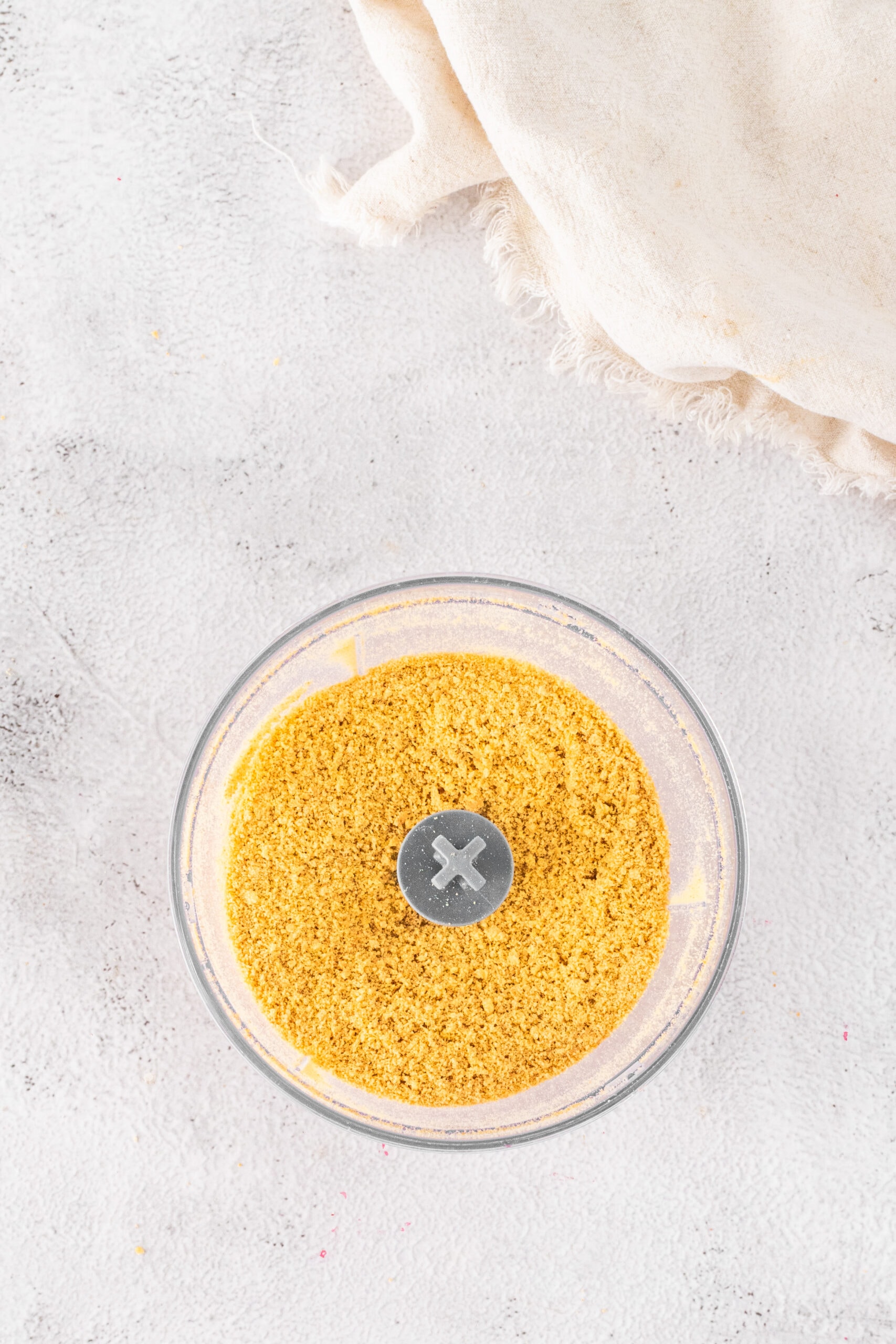 Placing Graham Crackers in a food processor to make crumbs