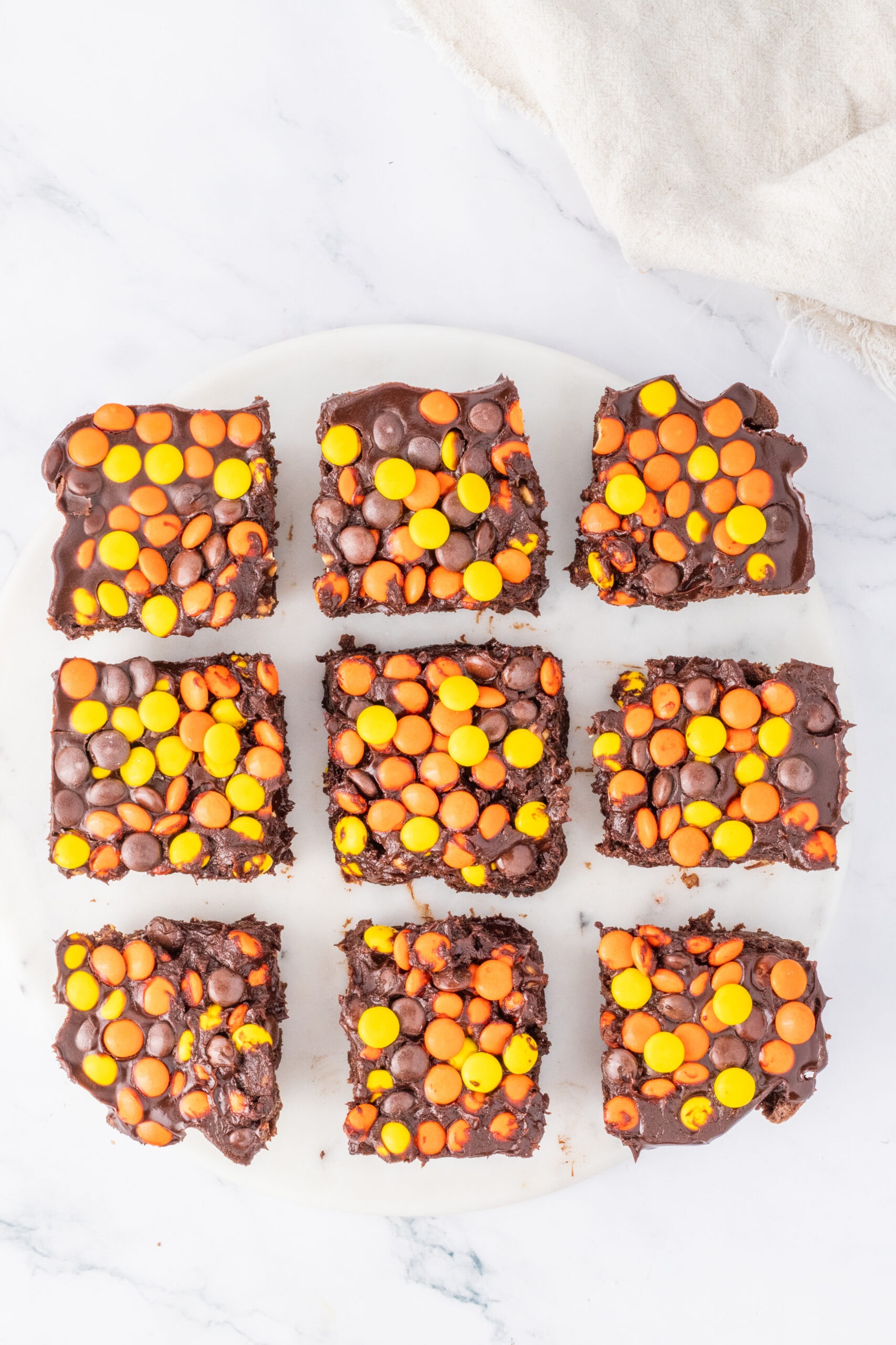 Reese's Pieces brownie cut into squares, ready to be enjoyed