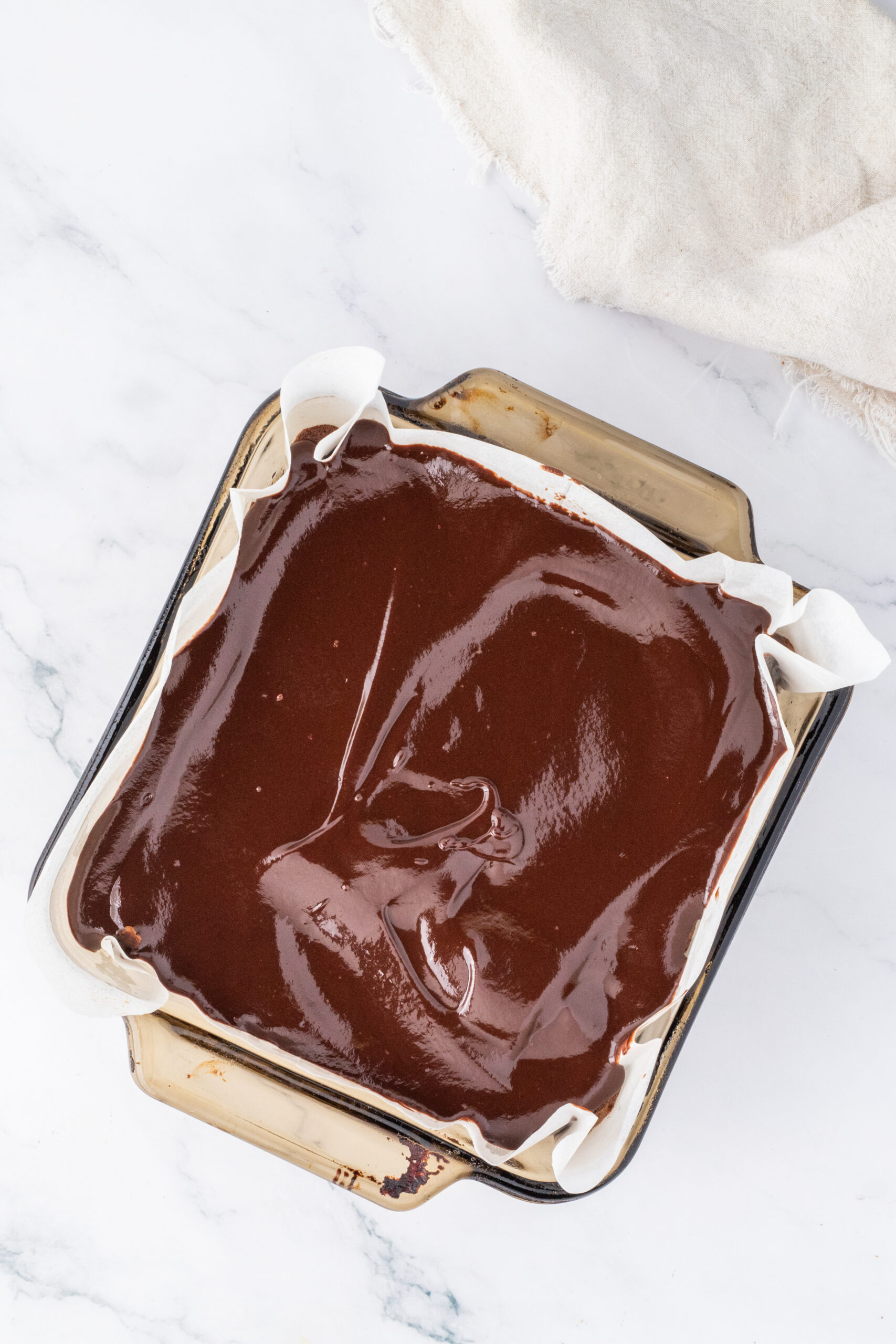 Chocolate ganache is layered on top of Reese's Pieces brownie batter