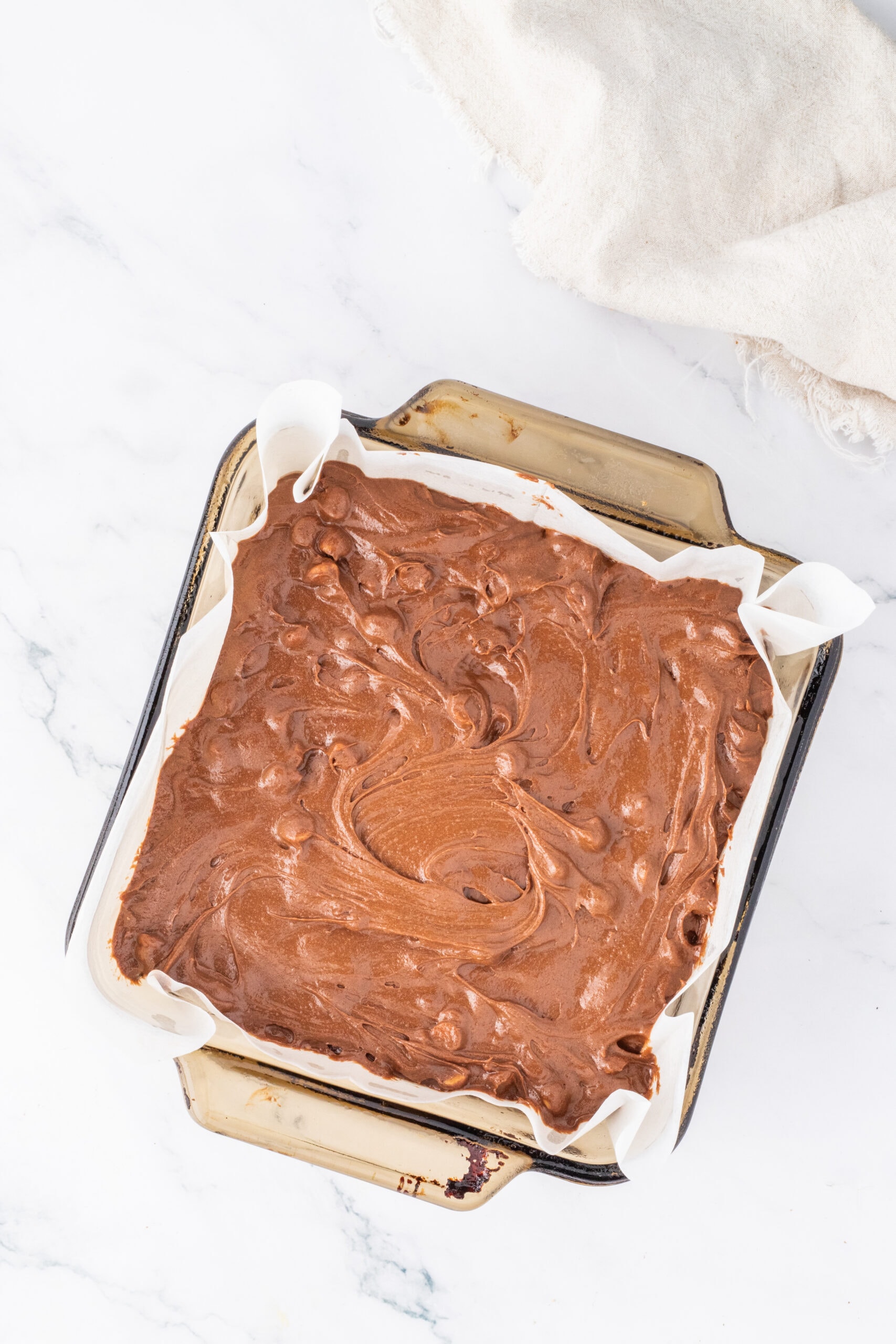 Brownie pan is filled with batter, Ready to be baked.