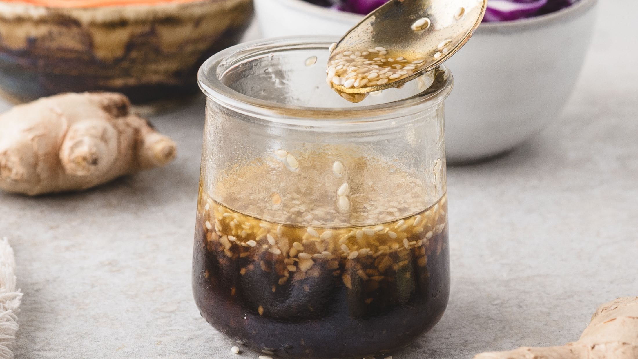 Sopping out a spoonful of sesame dressing to add to your salad