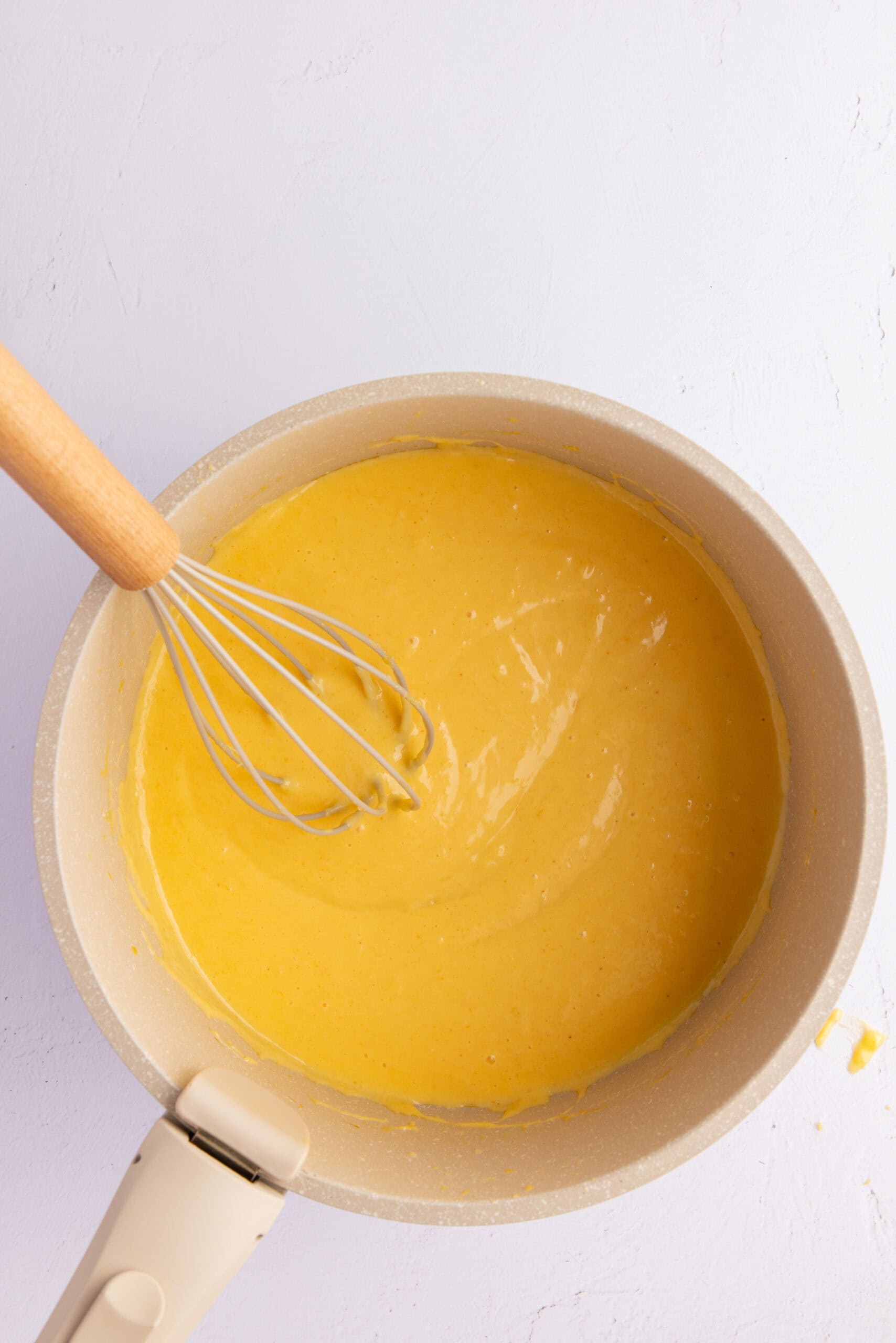 Mixing the cheese sauce in a saucepan: cornstarch, heavy cream, cheddar and mozarella cheese