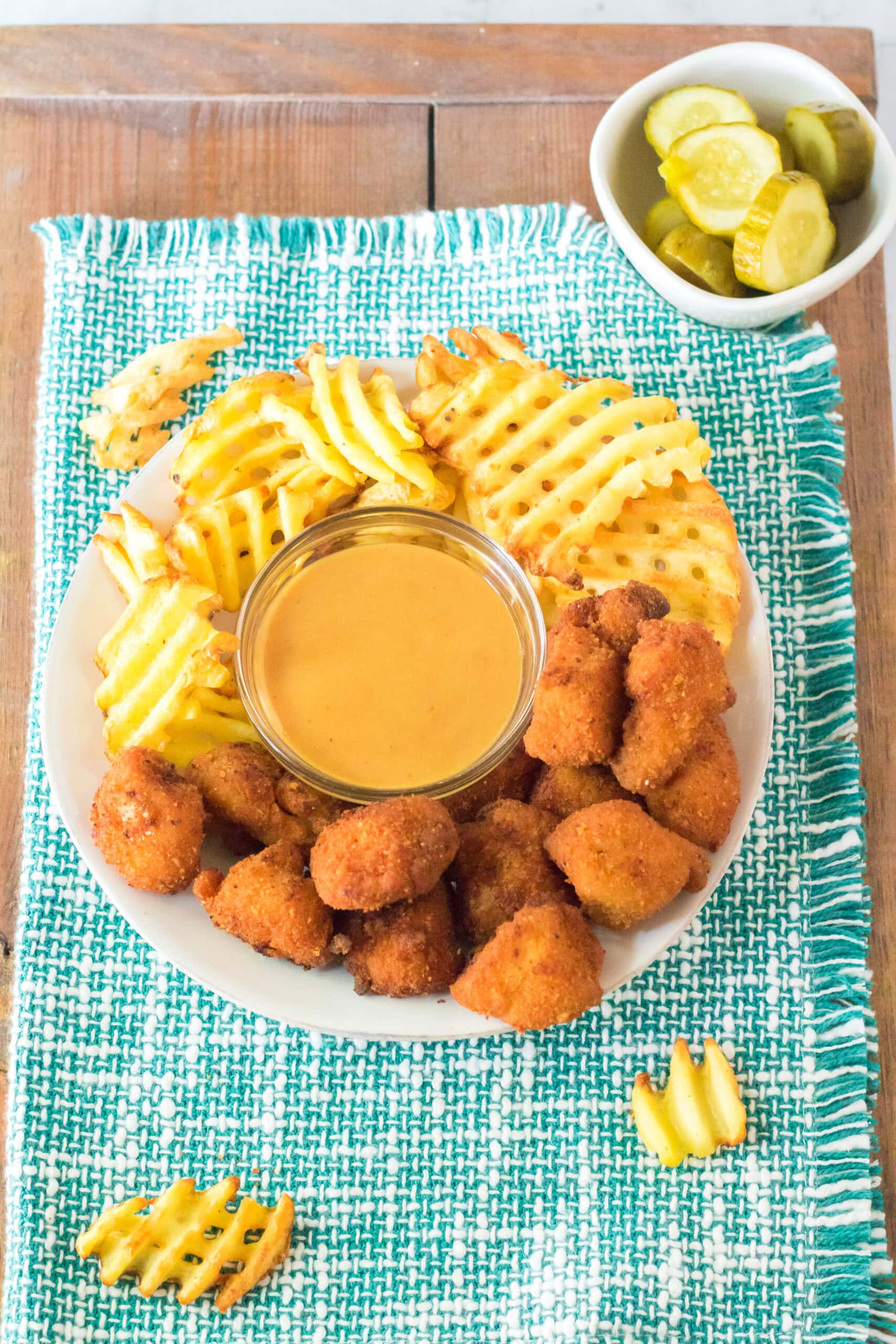 Chick Fil A sauce all made in a bowl, and served with waffle fries and nuggets around the sauce