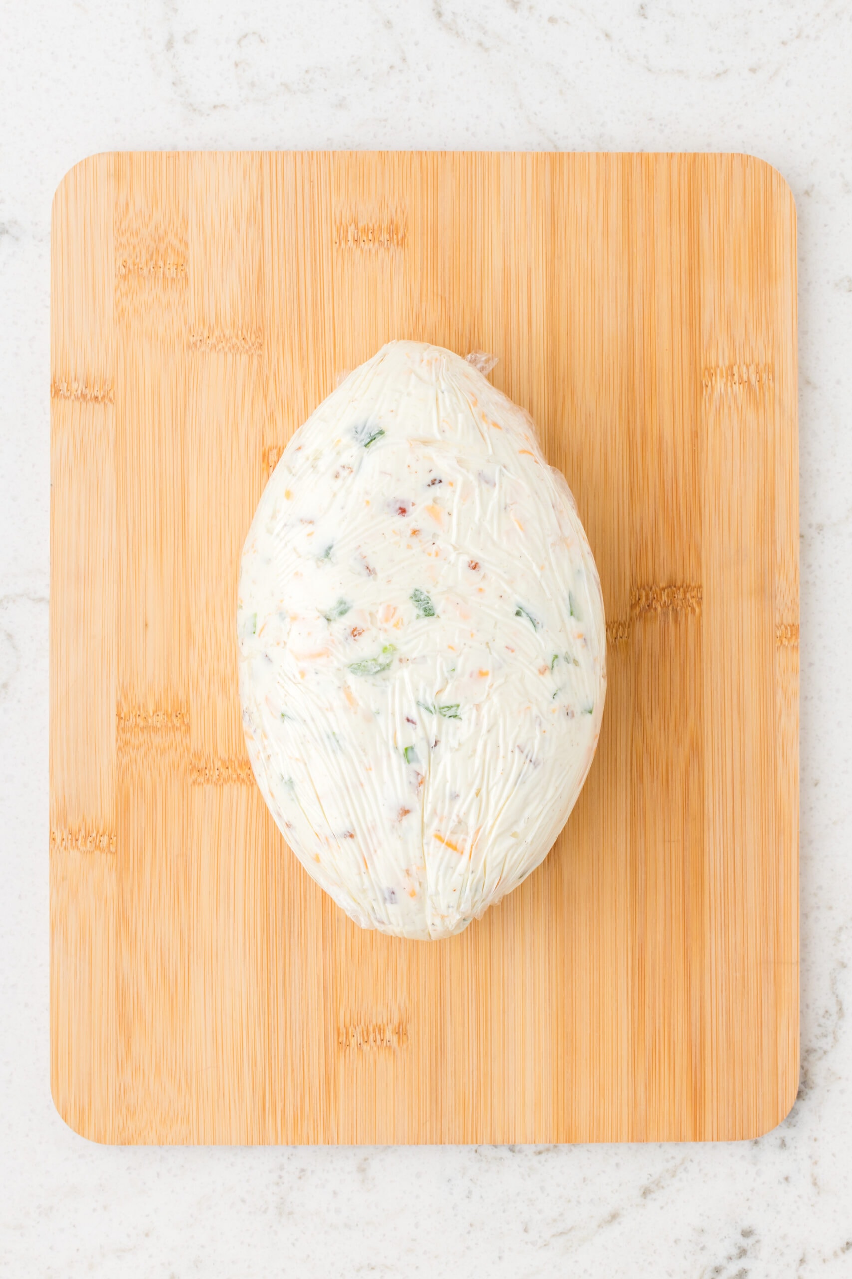 Creating the football shape with the cheese middle, ready to be chilled again to keep its shape