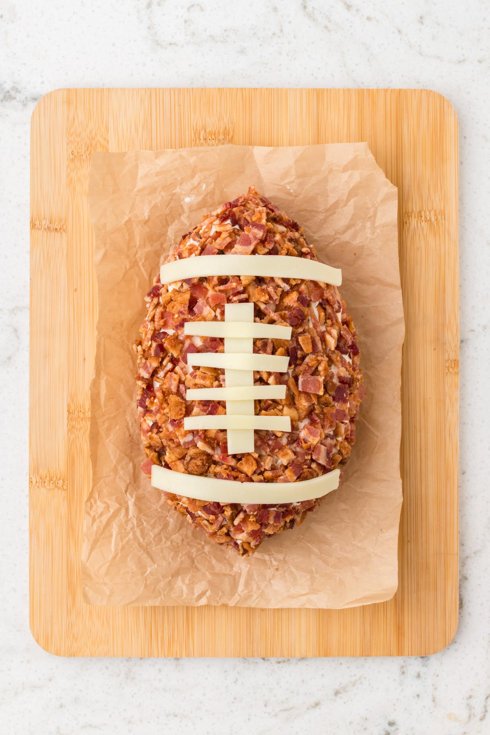 Cheeseball is all chilled and being served on a wood board