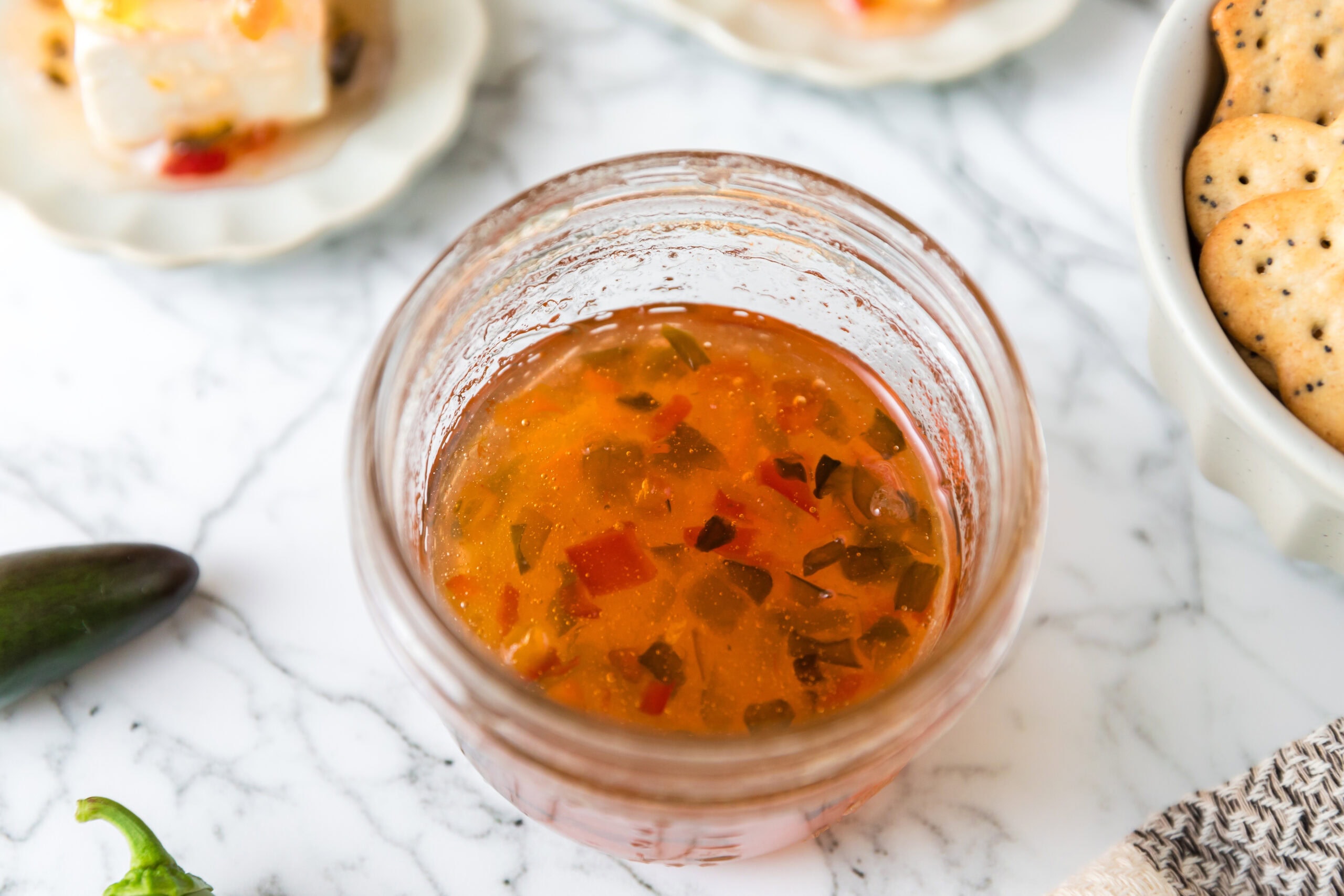 Pepper jelly in a jar, showing it's texture
