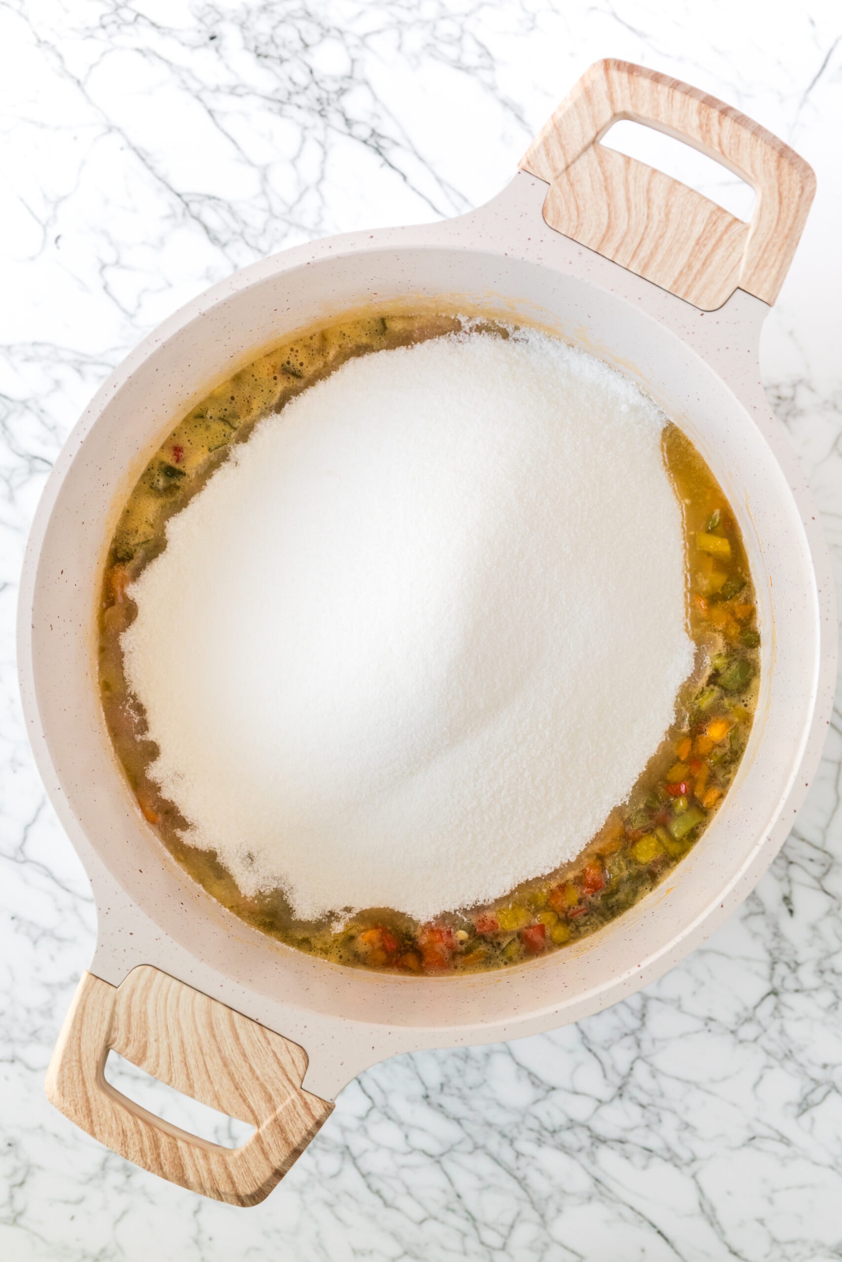 Boiling sugar in pepper jelly in a large pot