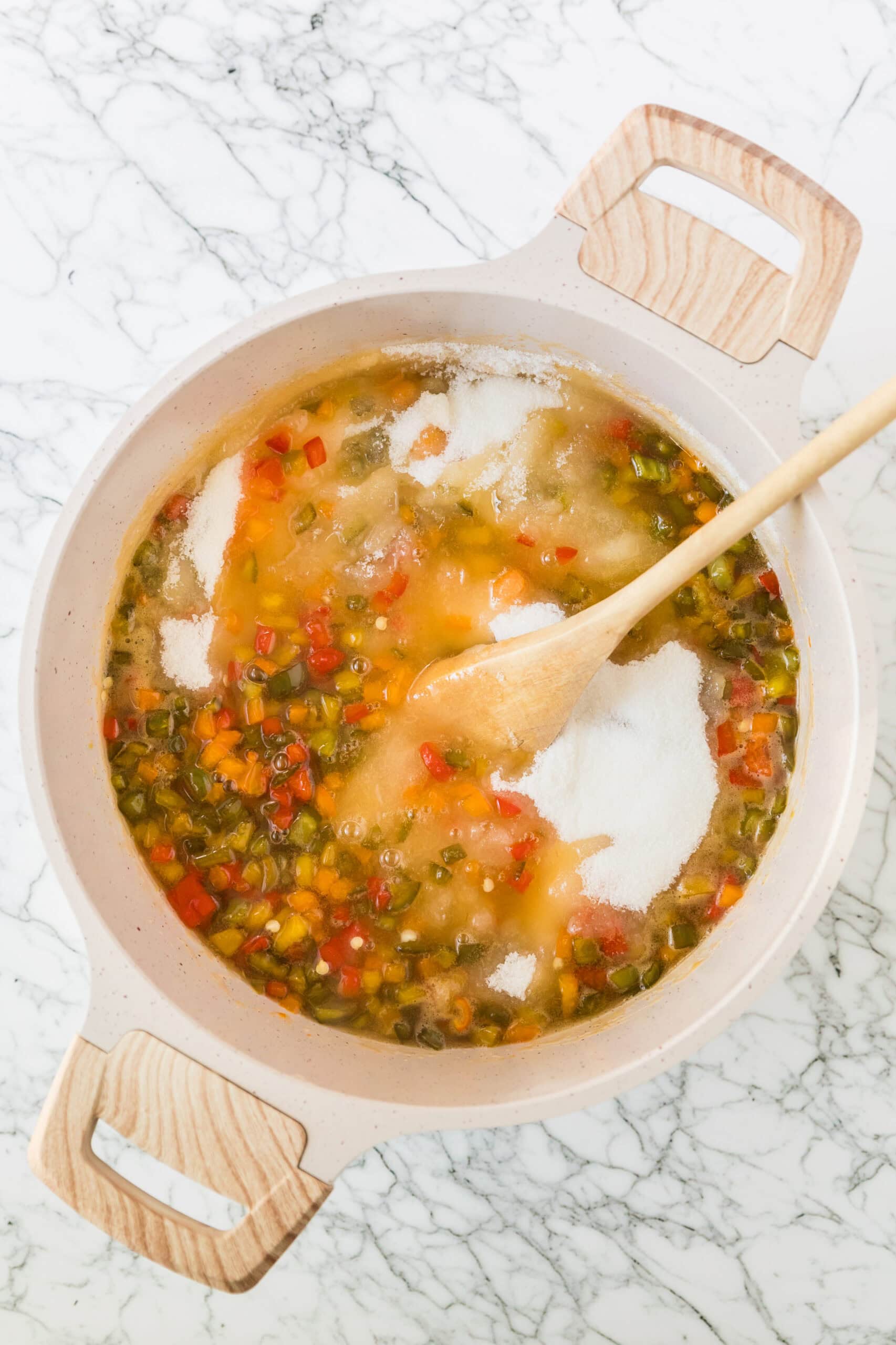 Adding sugar to the pepper jelly mixture in large pot