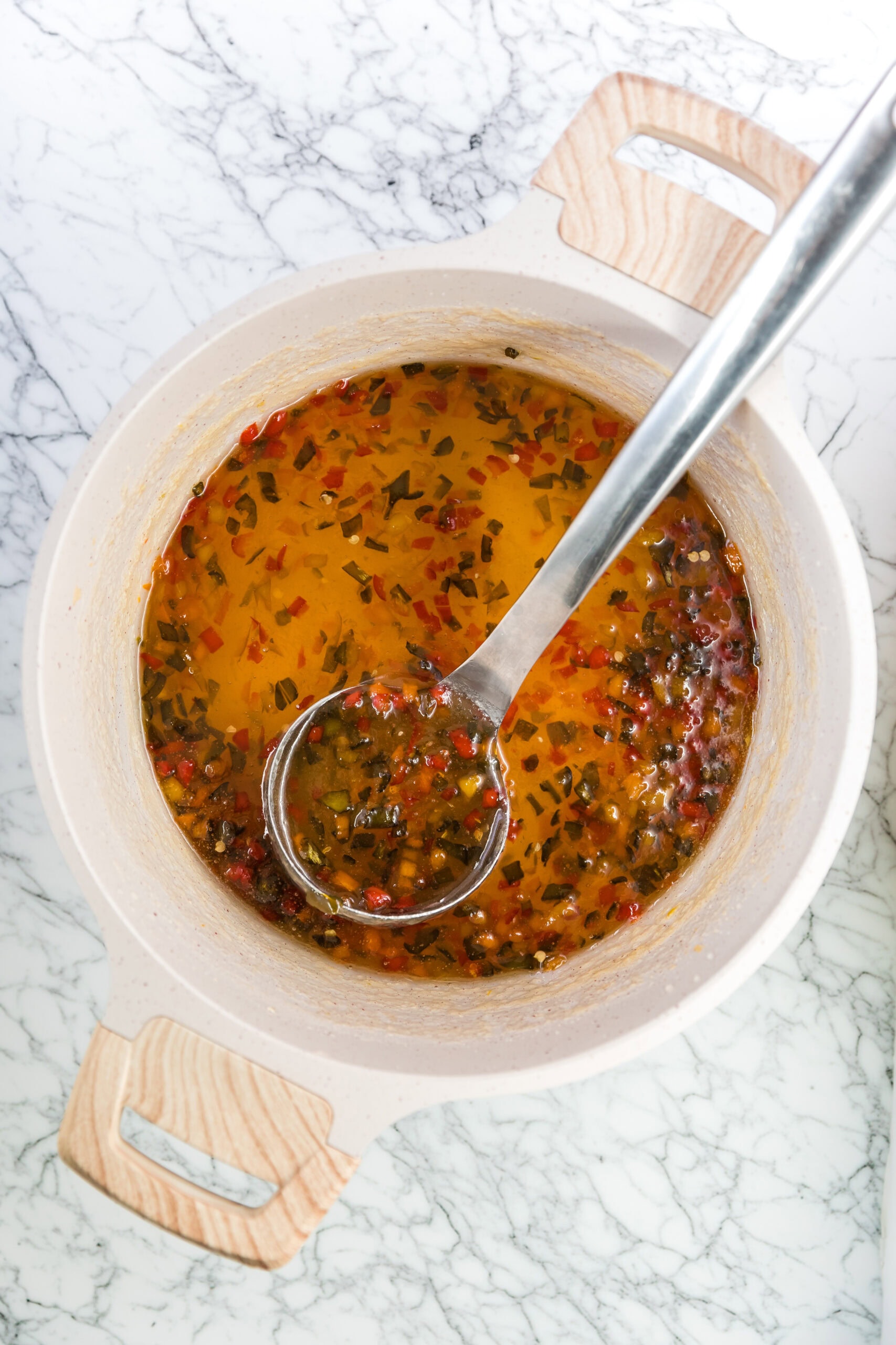 Hot pepper jelly in a large pot, already boiled and now cooling