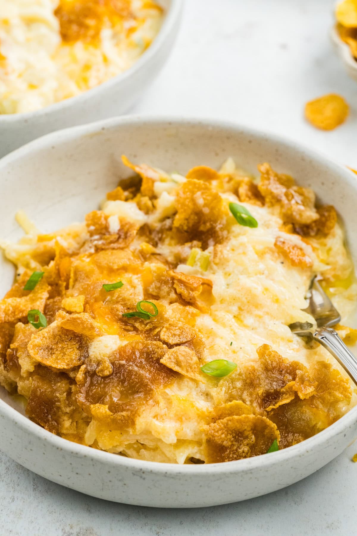 Close up of a bowl of cheesy potatoes