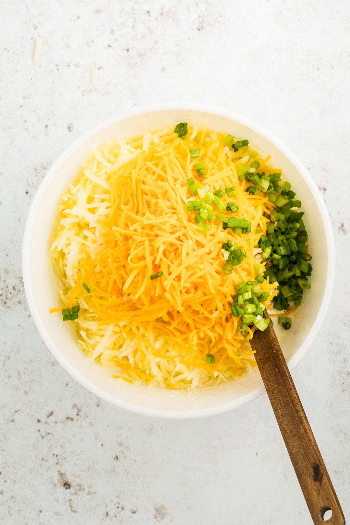 In a small bowl: cheddar cheese, green onion, thawed hash browns