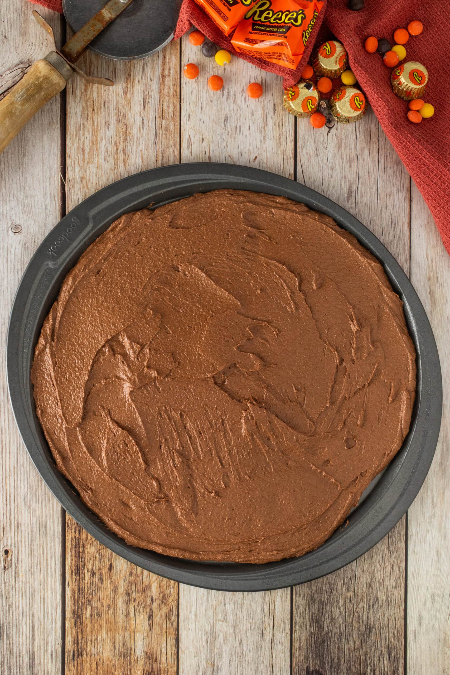 Brownie batter is ready in the baking round pan, ready to go into the oven