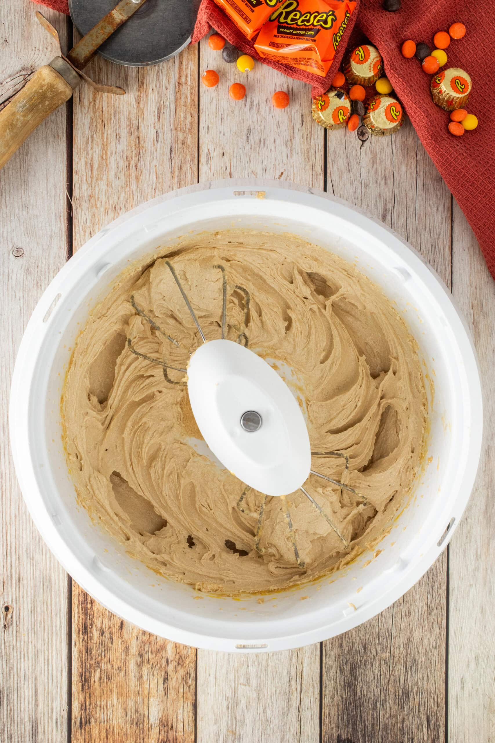 Mixing soft butter with brown and white sugar in a large bowl