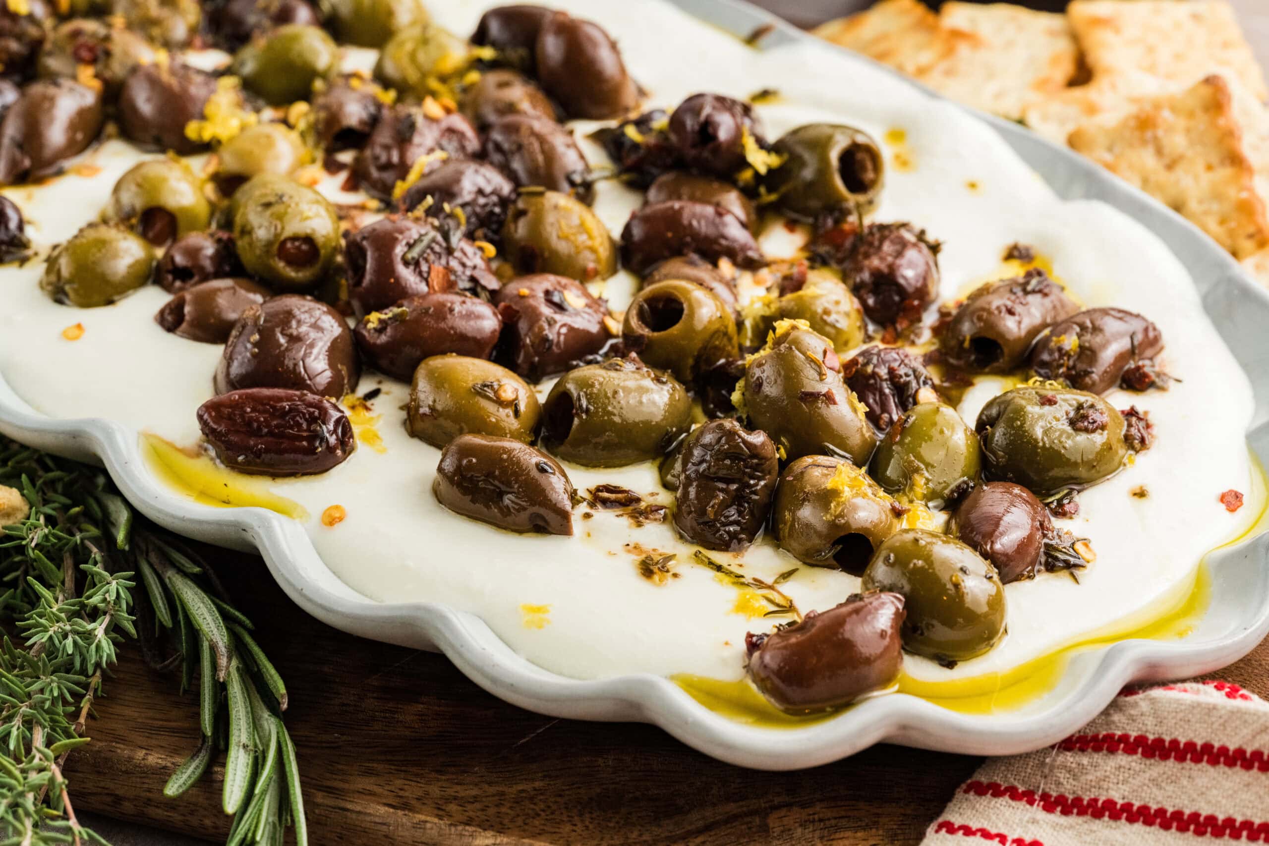 Whipped Feta with olives on a white plate