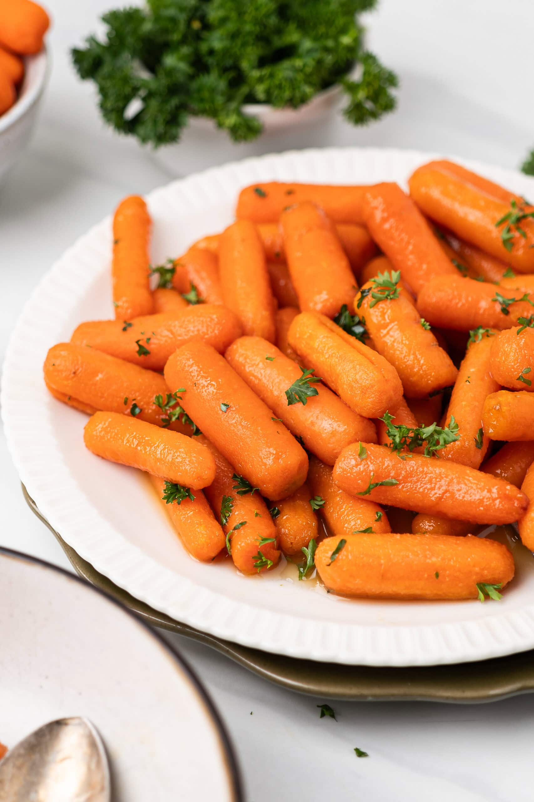 Air fryer baby carrots on a plate, ready to be served.
