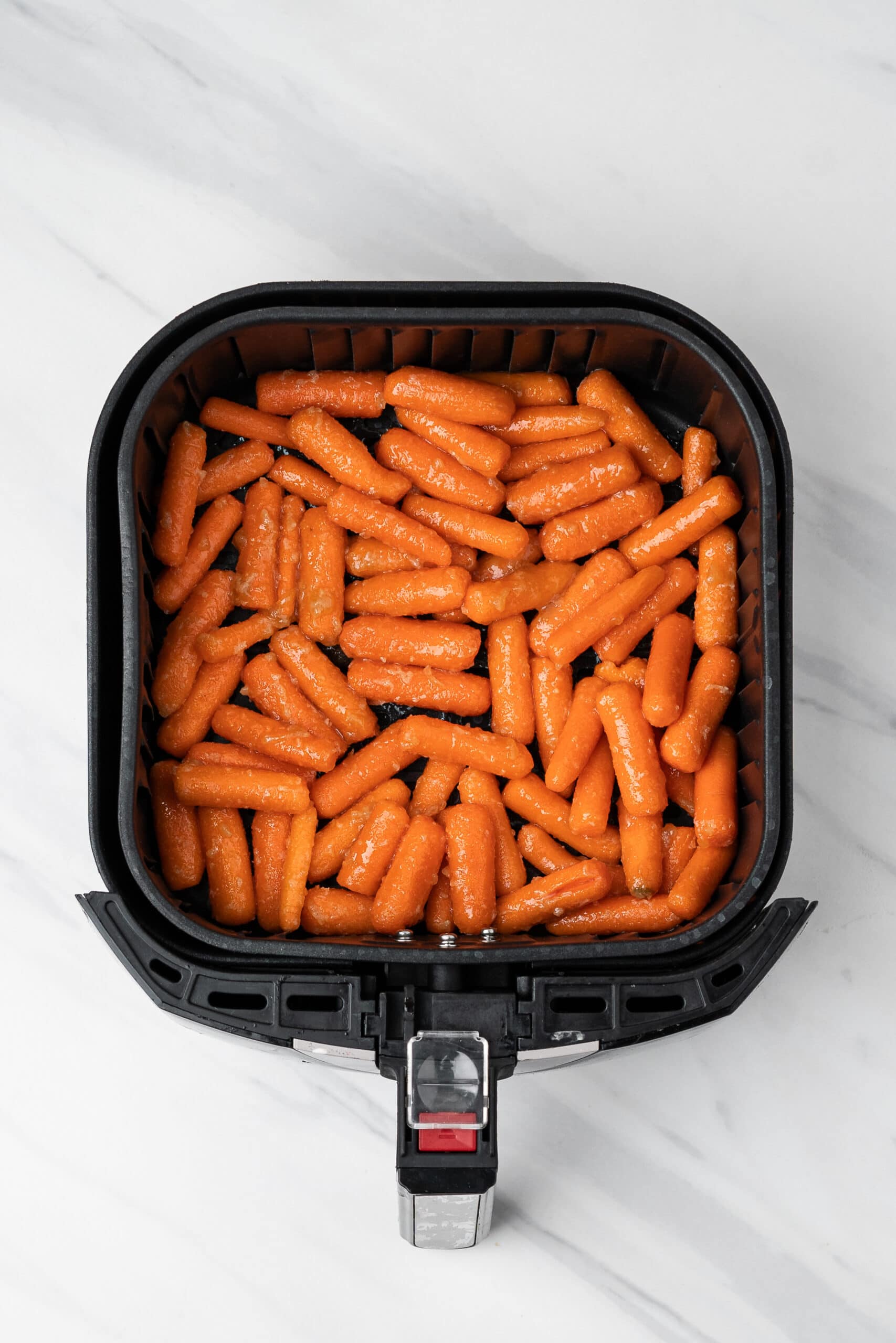 Coated Air Fryer baby carrots in the air fryer