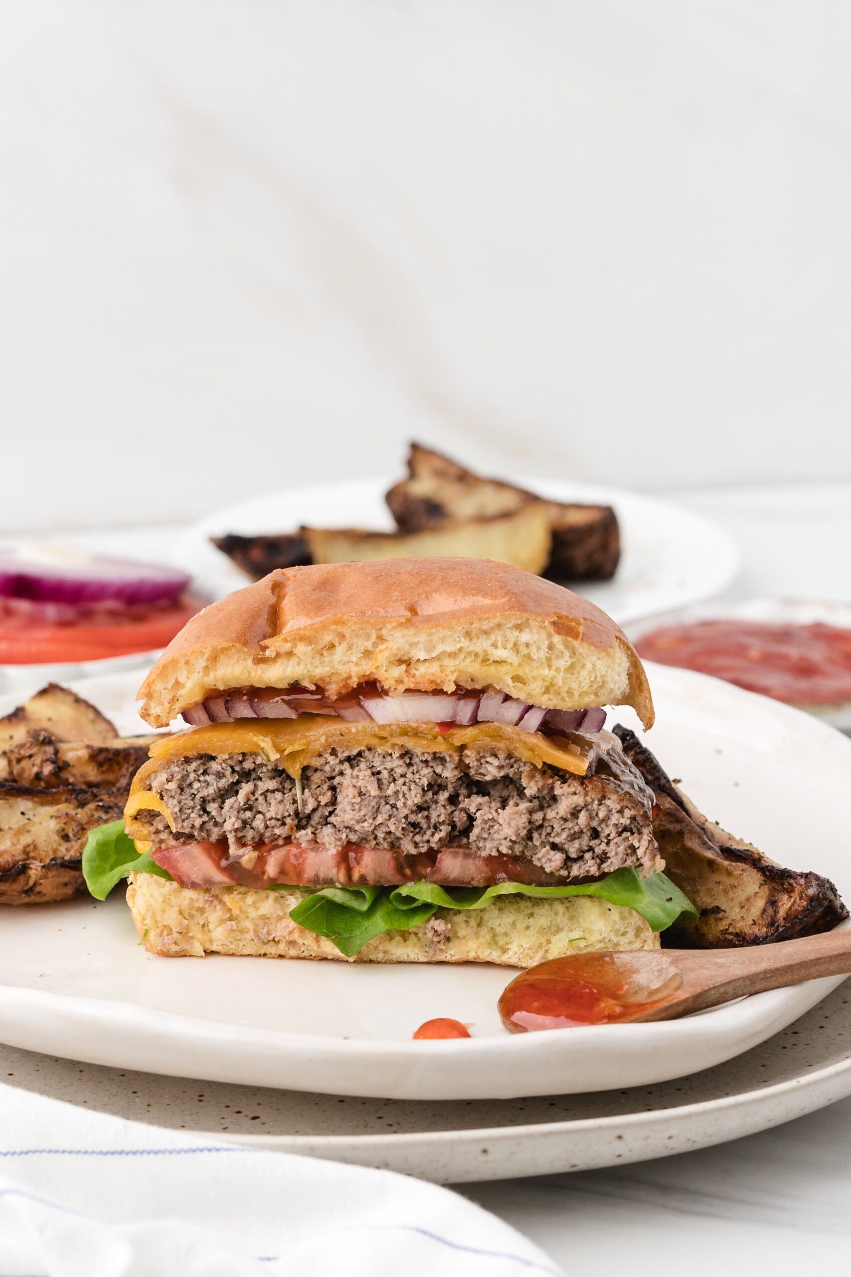 Air fryer turkey burger cut in half with toppings to see the texture of the inside of the burgers