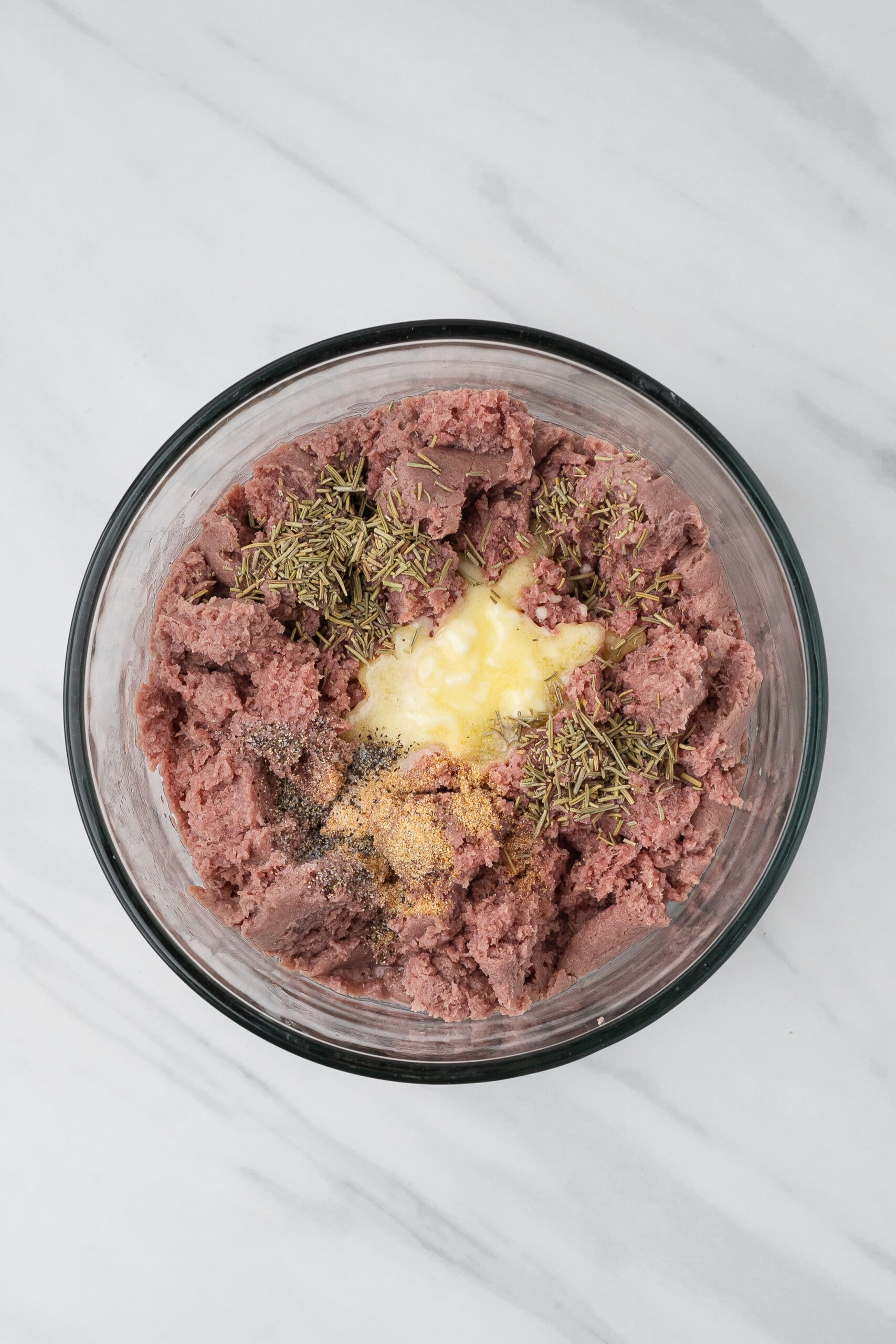 Ground turkey, dried rosemary, garlic powder, salt and pepper in a bowl to be mixed up together to create burgers