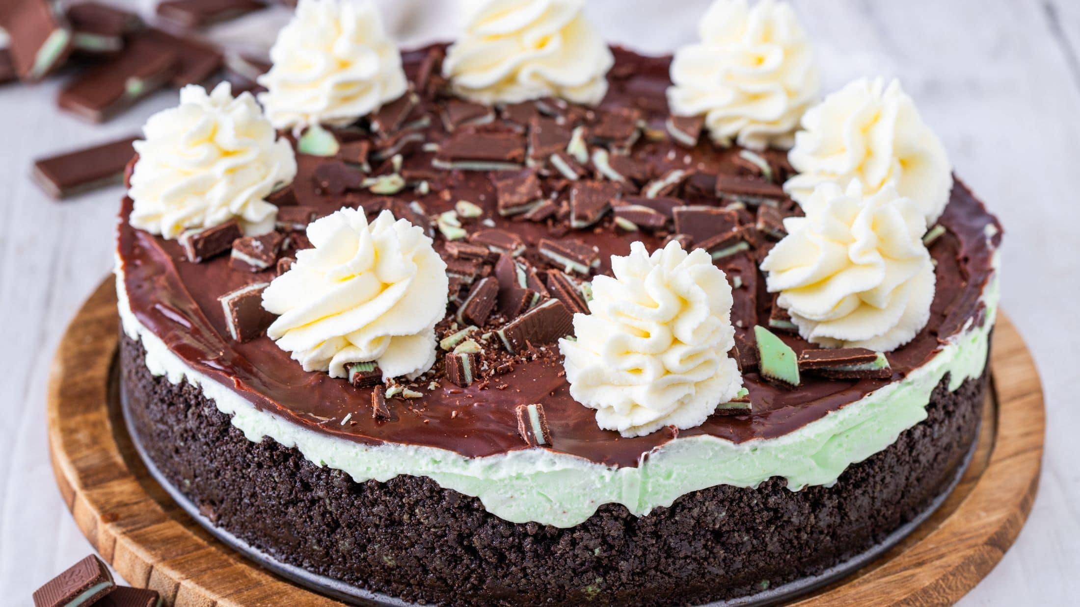 Andes Mint cheesecake on a wooden board, ready to be enjoyed
