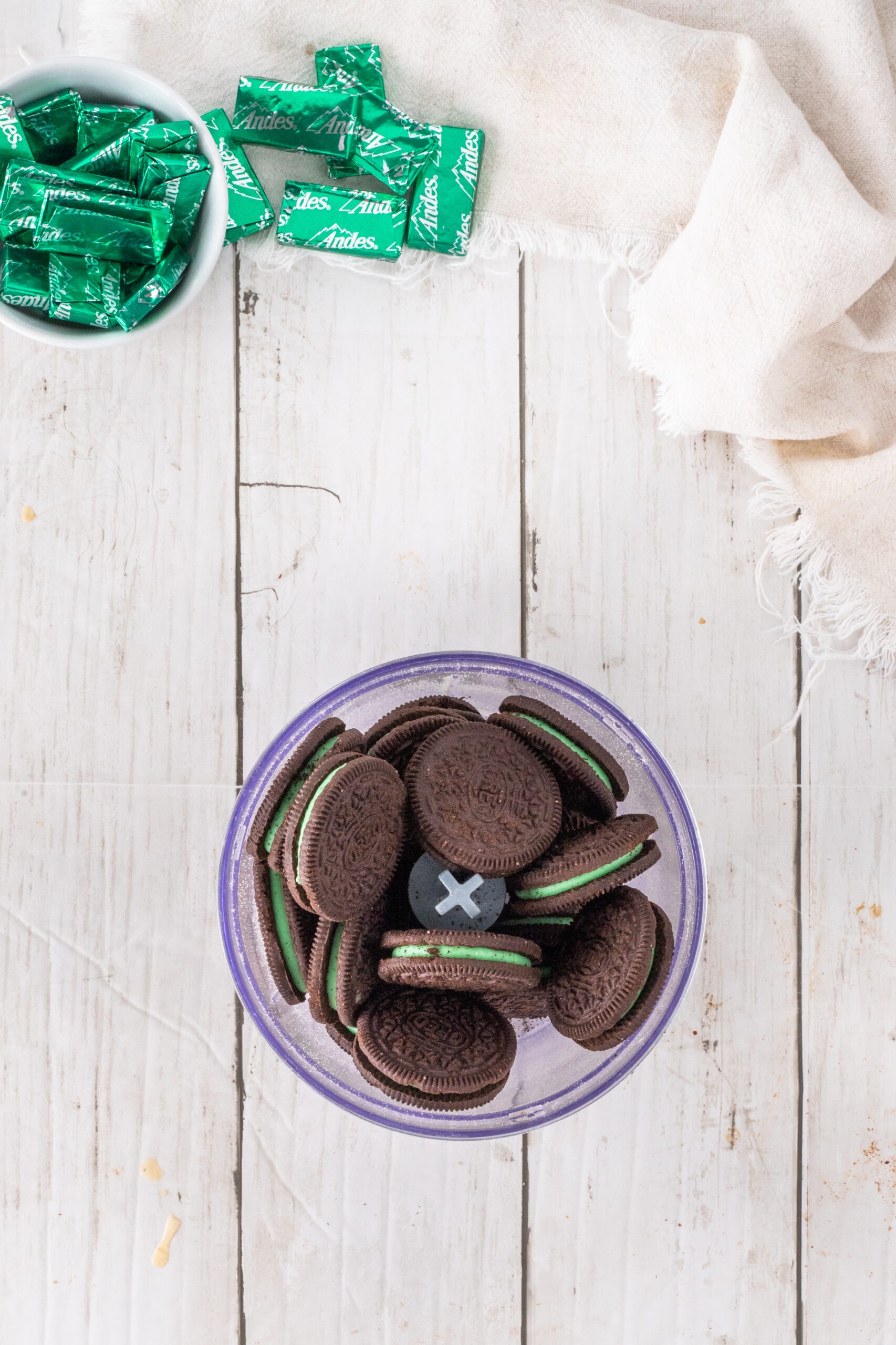 Mint cookies in a food processor getting ready to be crushed in a food processor