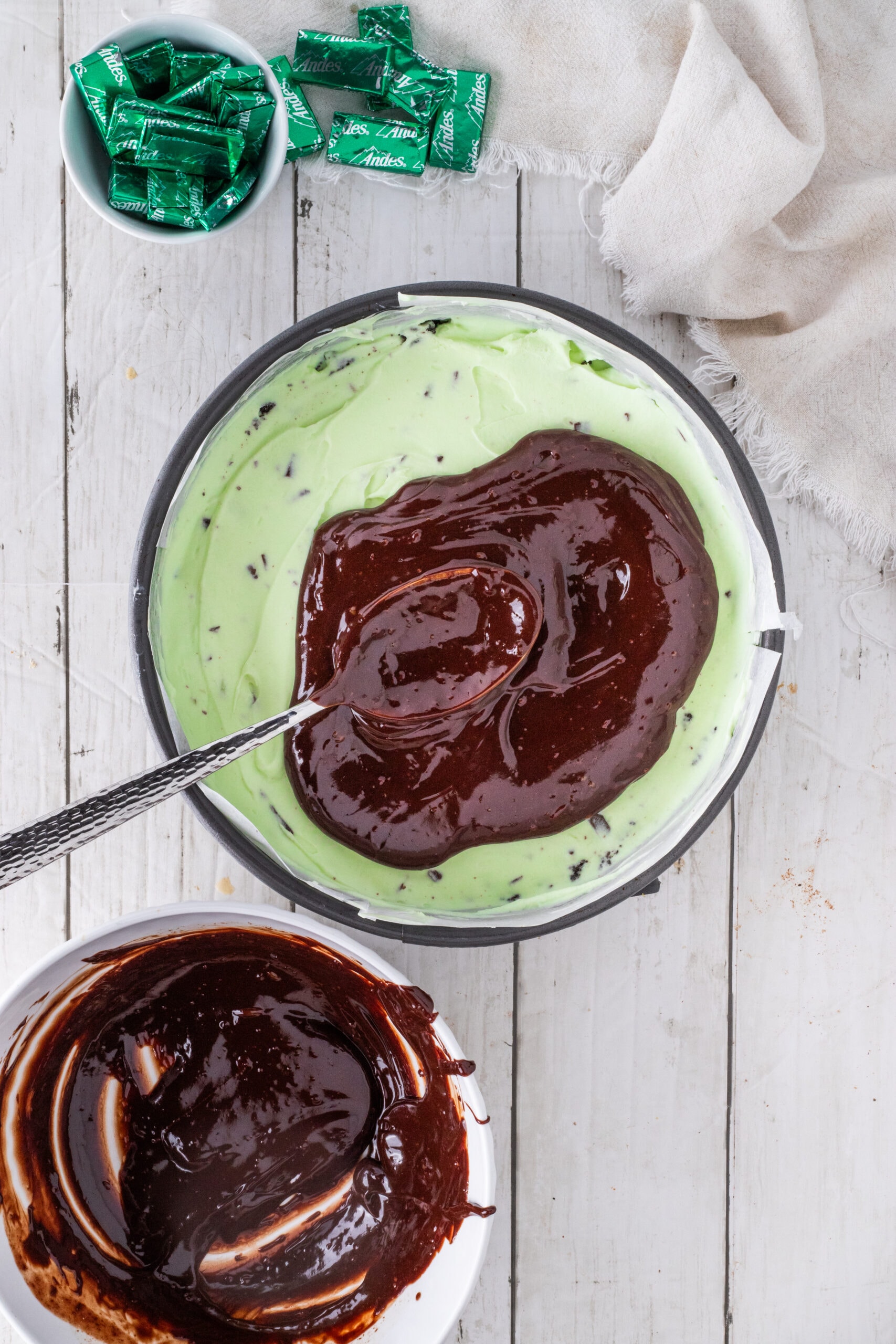 Swirling homemade. ganache on top of cheesecake layer