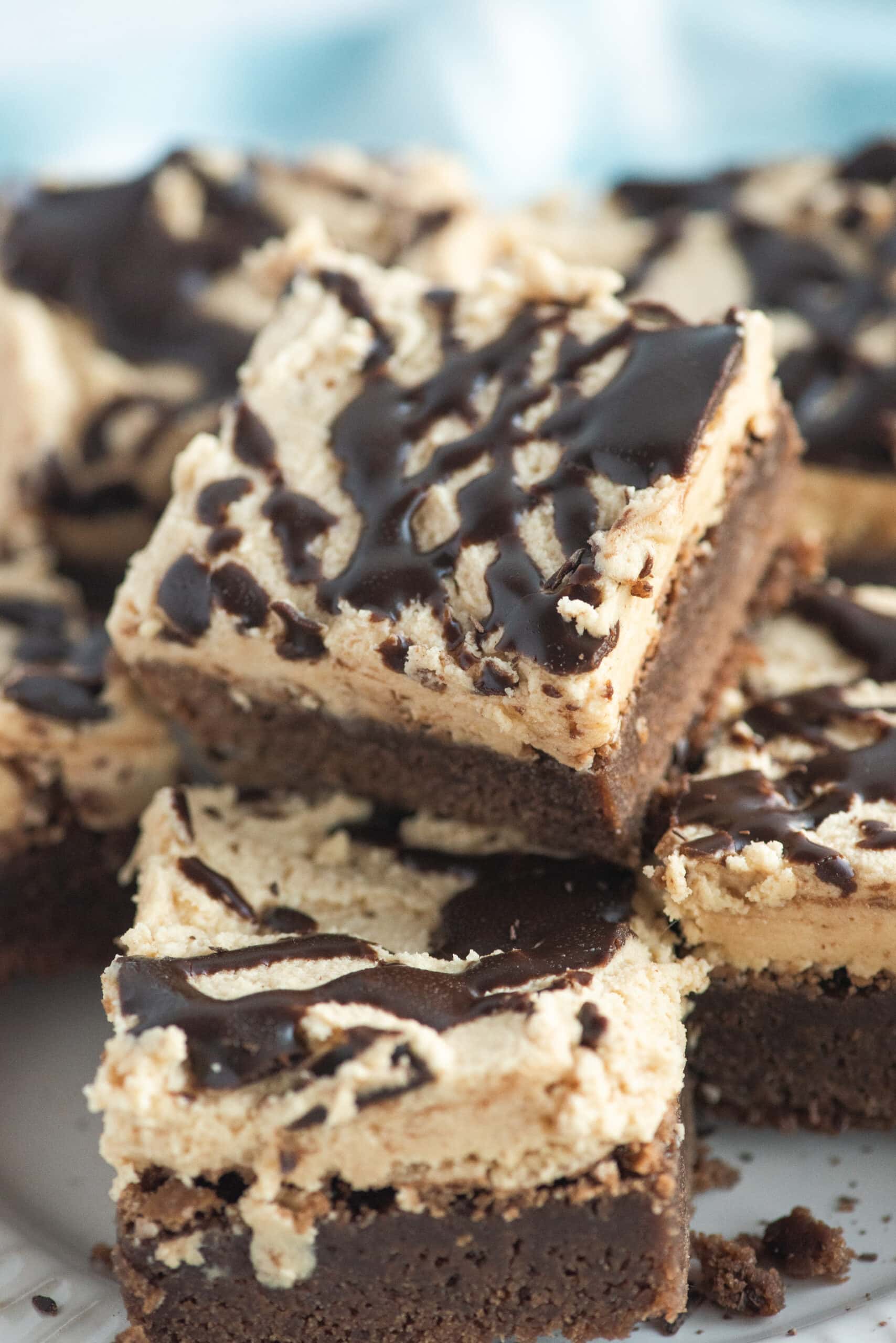A stack of brownies with peanut butter brownies on a plate