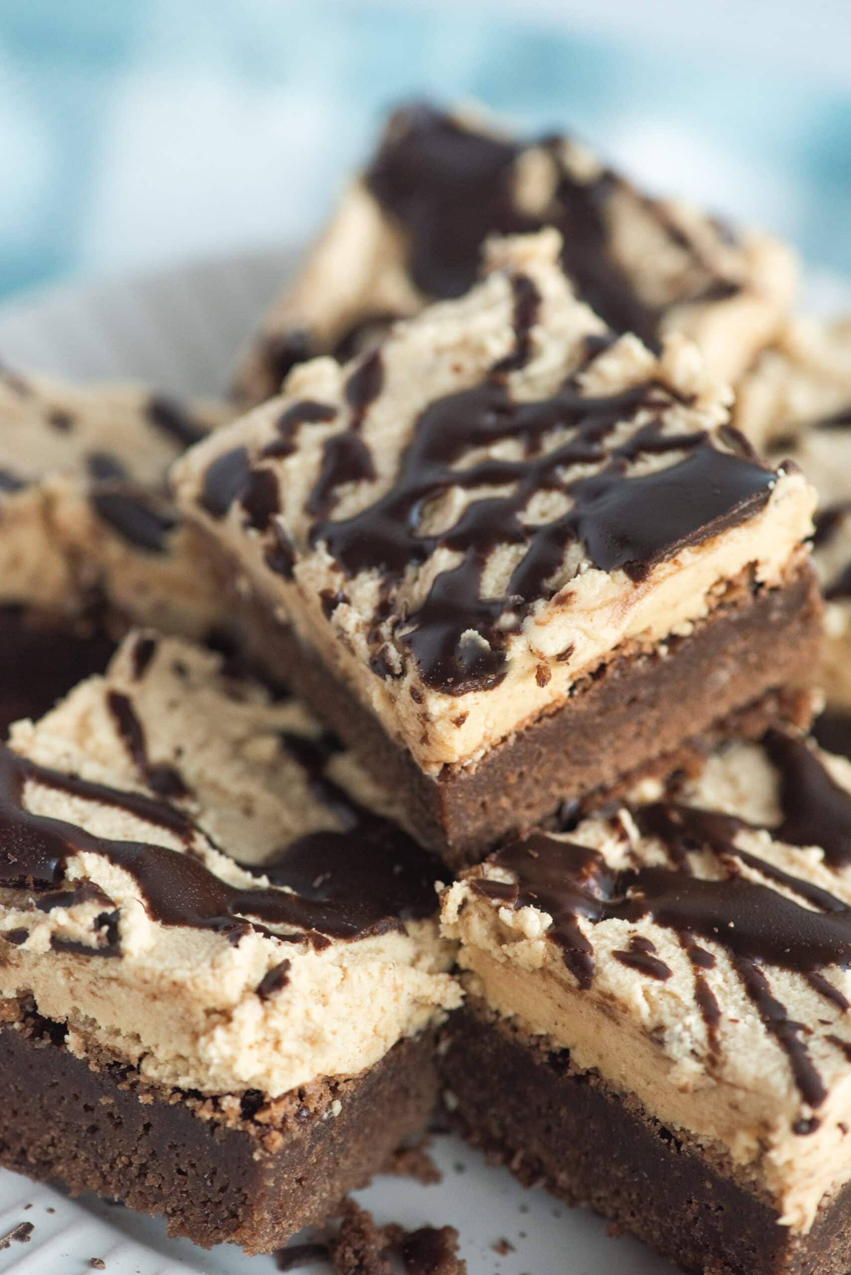 A stack of brownies with peanut butter frosting