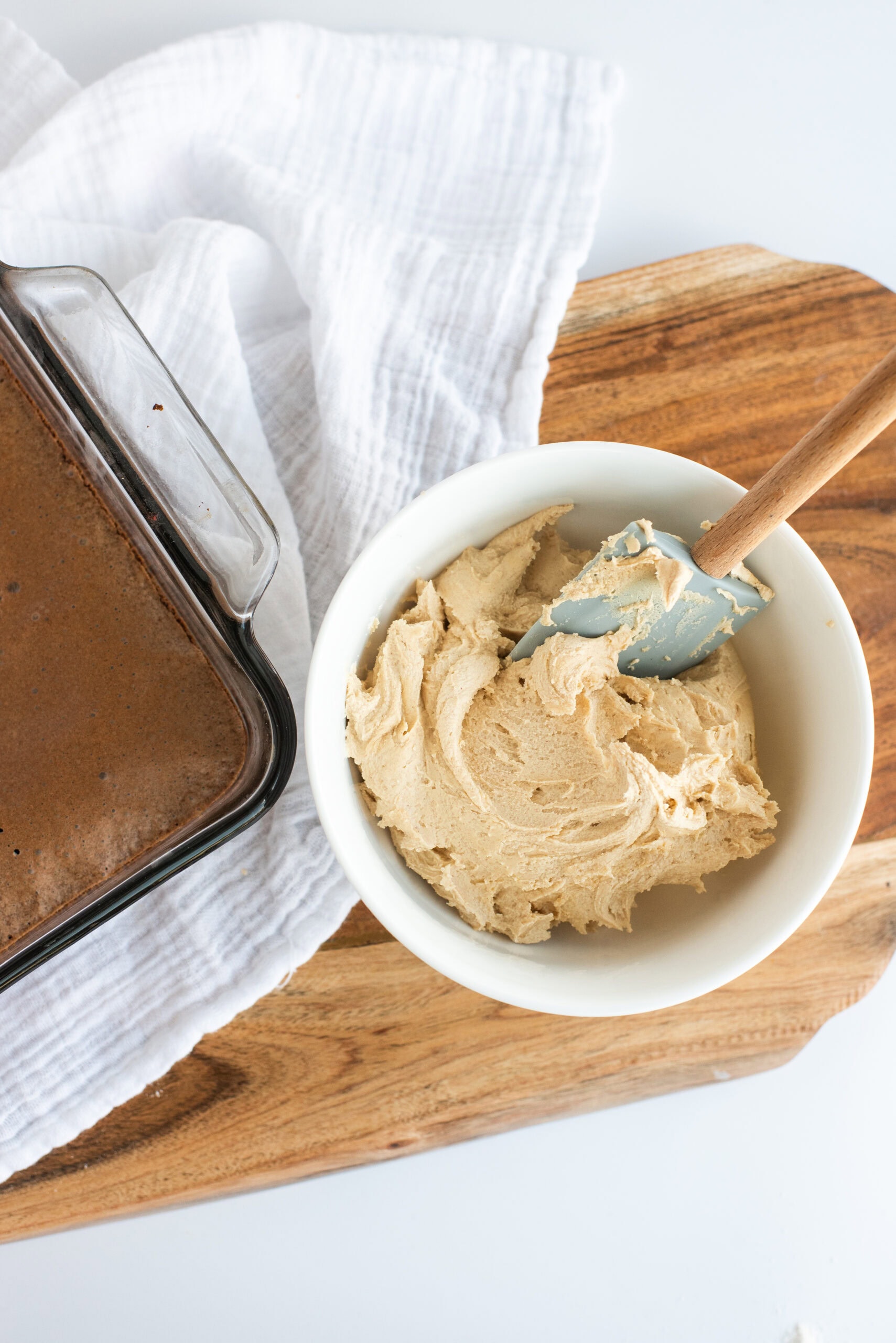 Making the peanut. butter frosting in a cup, with peanut butter, powdered sugar, butter and milk