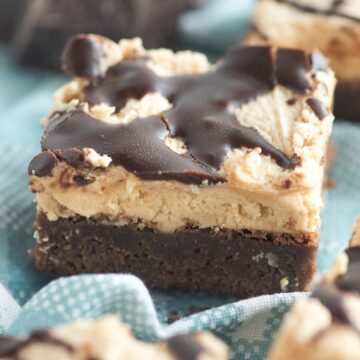 Close up of a stack of brownies with peanut butter frosting
